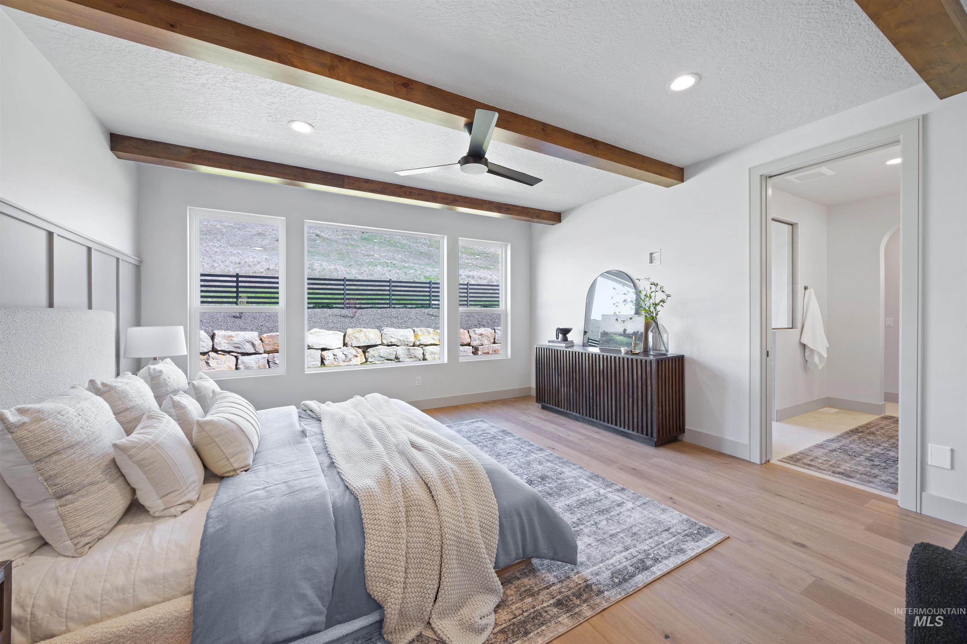 Bedroom with beam ceiling, recessed lighting, a textured ceiling, light wood finished floors, and ceiling fan