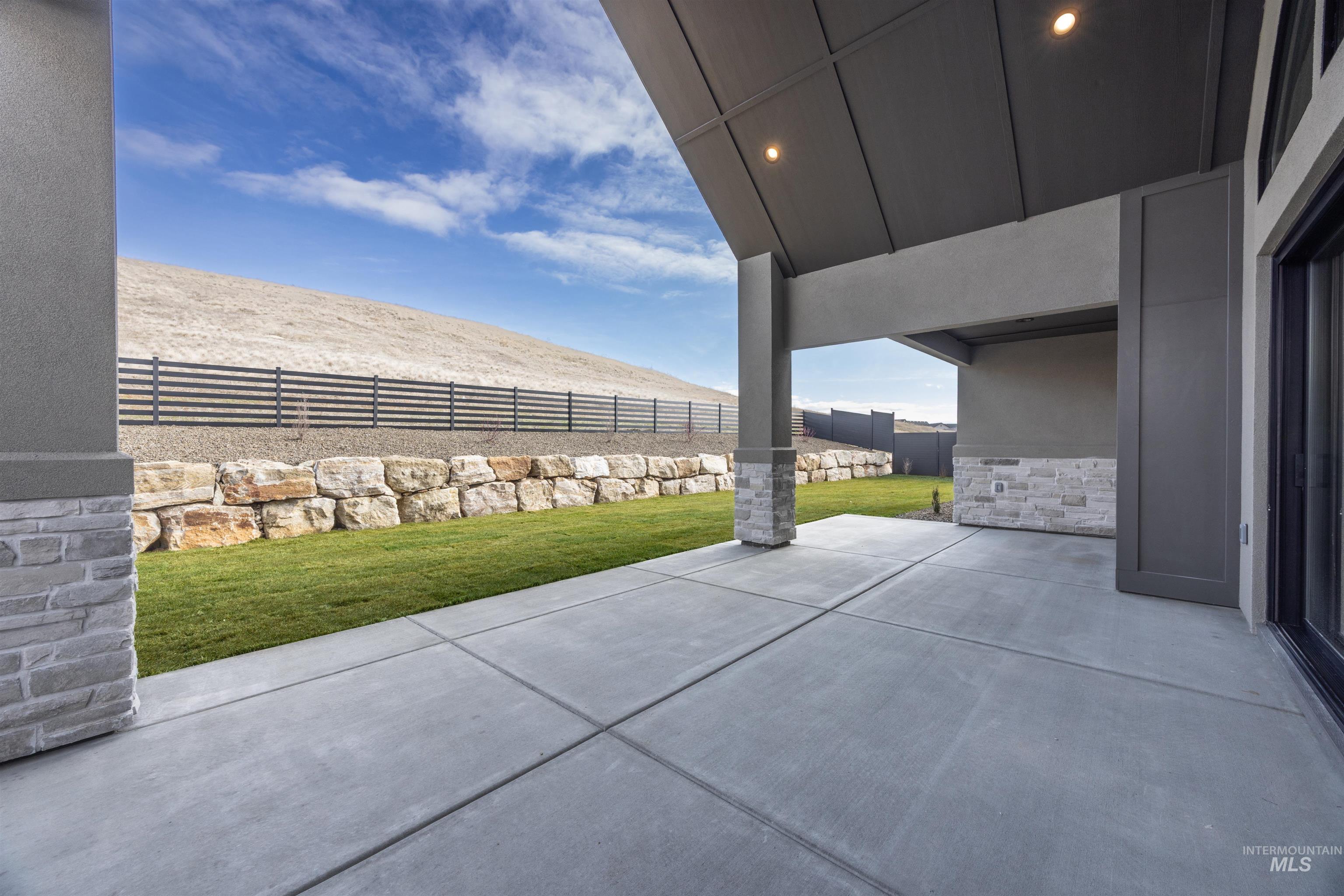 Fenced backyard featuring a patio area and a mountain view