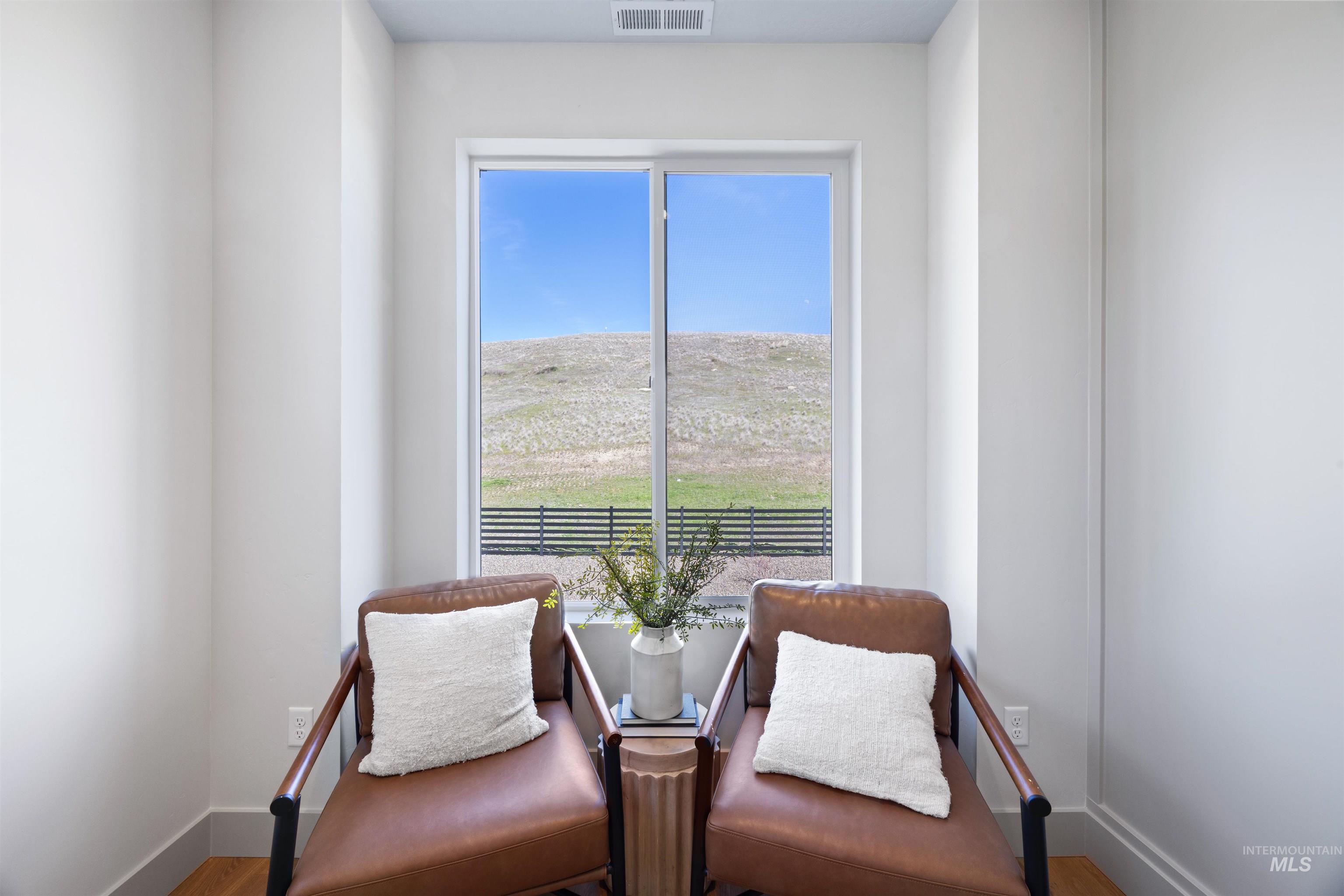 Living area featuring baseboards and wood finished floors