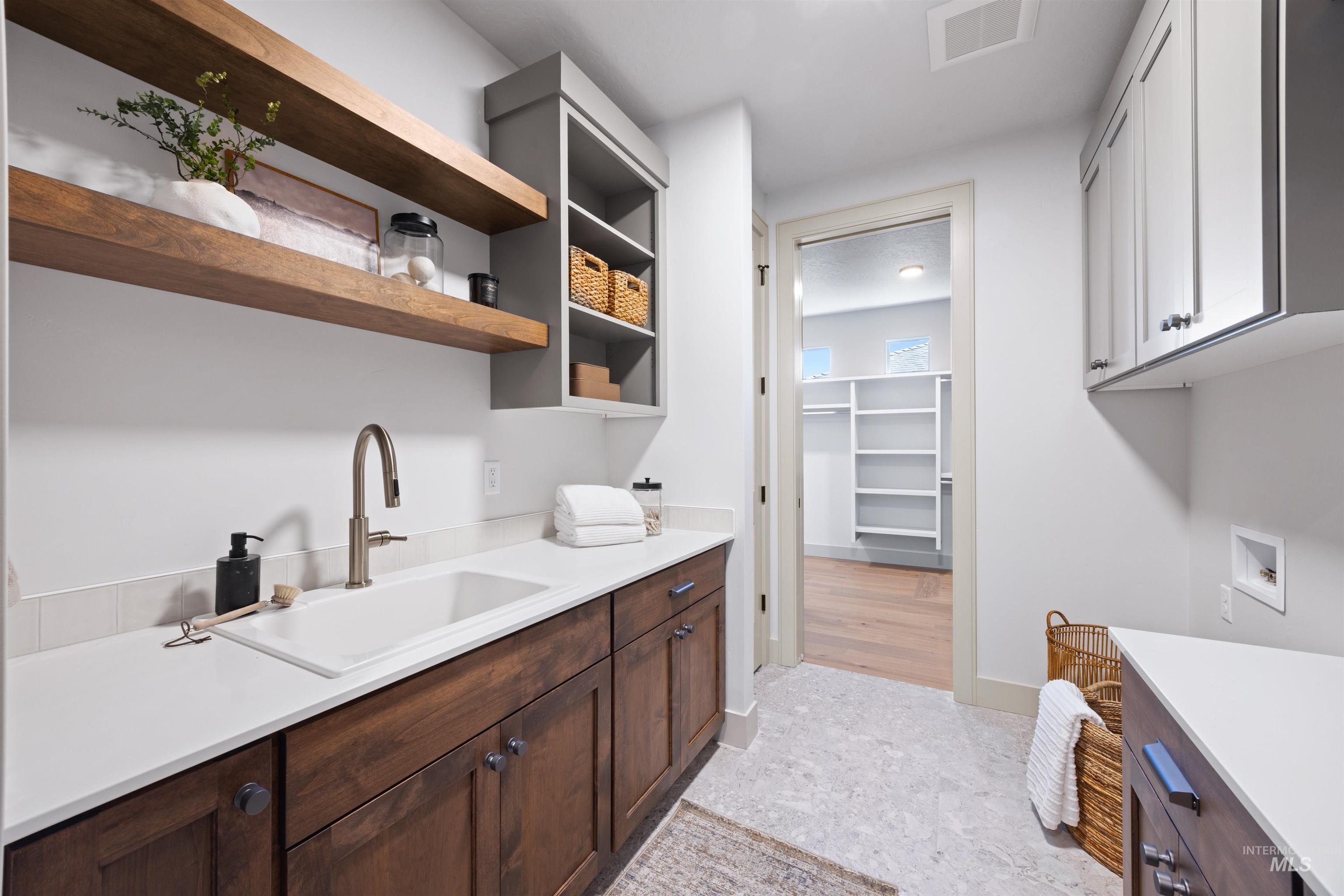 Laundry area with cabinet space and washer hookup