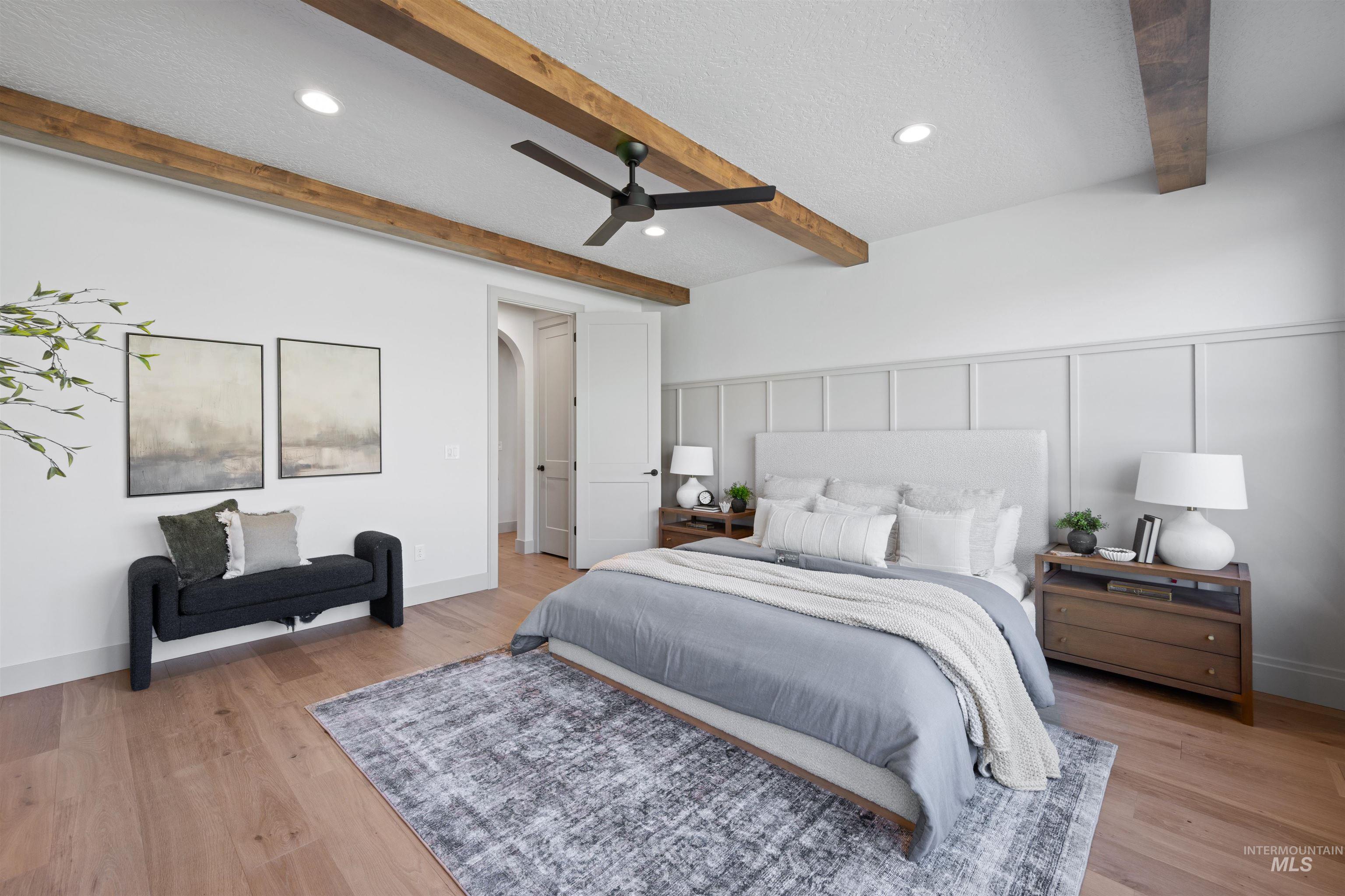 Bedroom featuring a decorative wall, light wood finished floors, recessed lighting, beam ceiling, and a ceiling fan