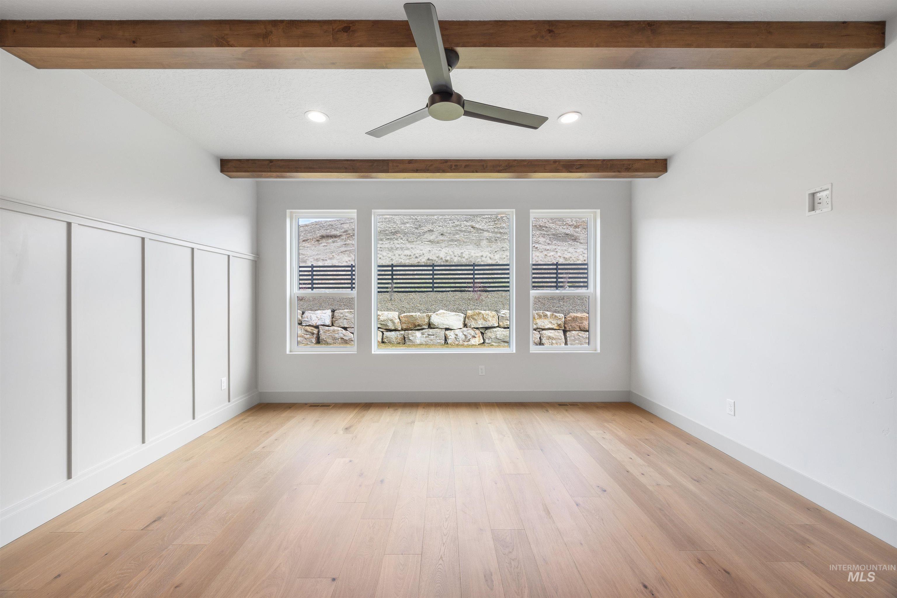 Empty room featuring a ceiling fan, recessed lighting, light wood-style flooring, and beam ceiling
