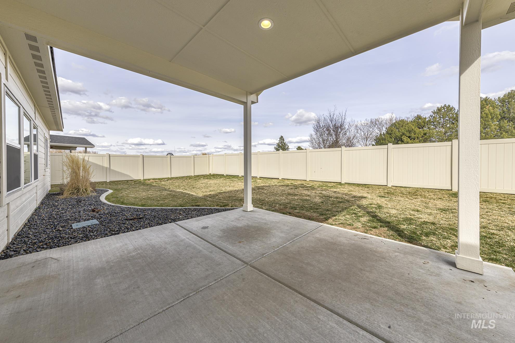 Fenced backyard featuring a patio