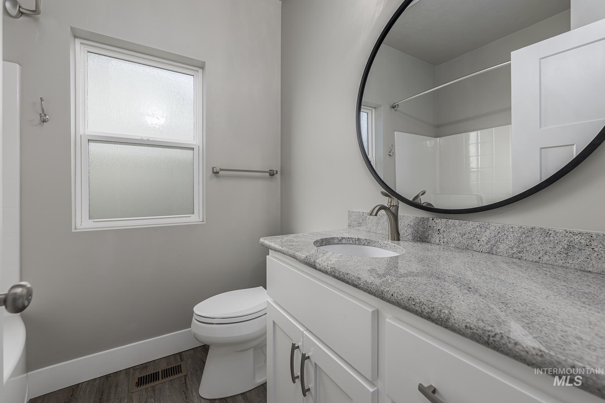 Full bath with vanity, a shower, wood finished floors, and a bath