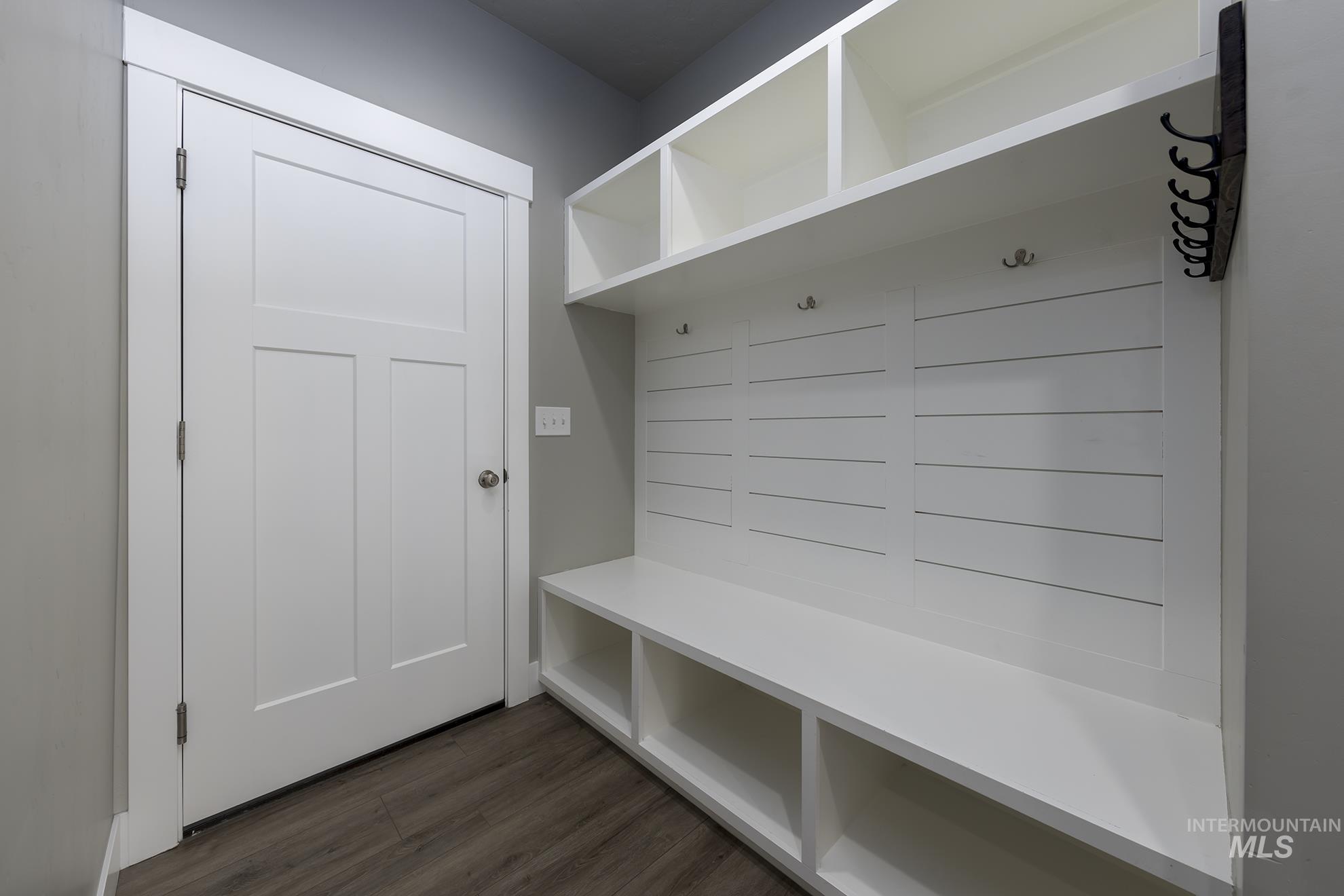 Mudroom with dark wood finished floors