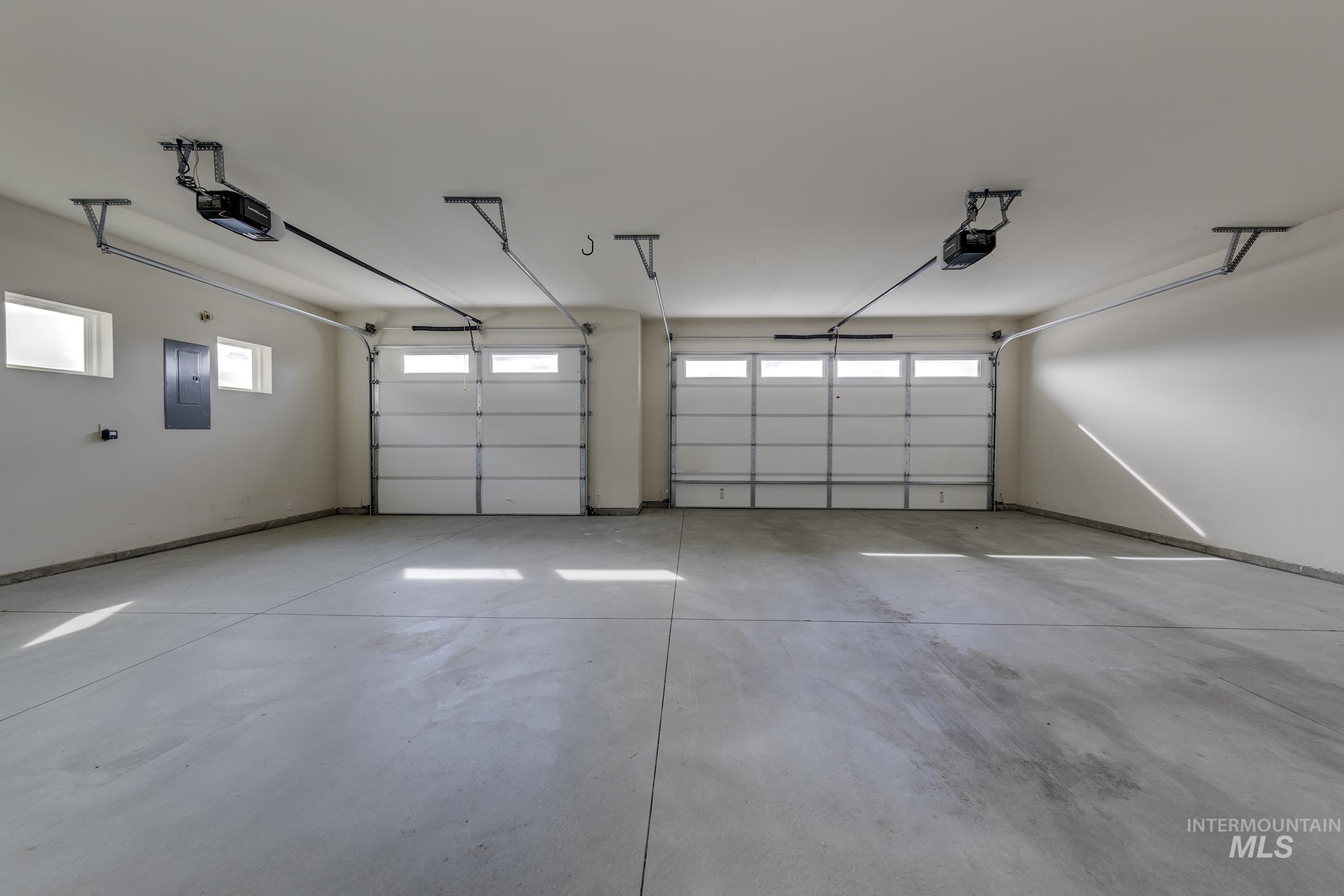 Garage with electric panel and a garage door opener