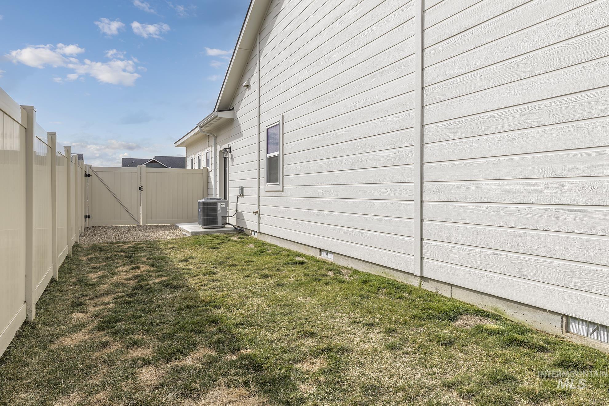 View of home's exterior featuring a gate and a fenced backyard