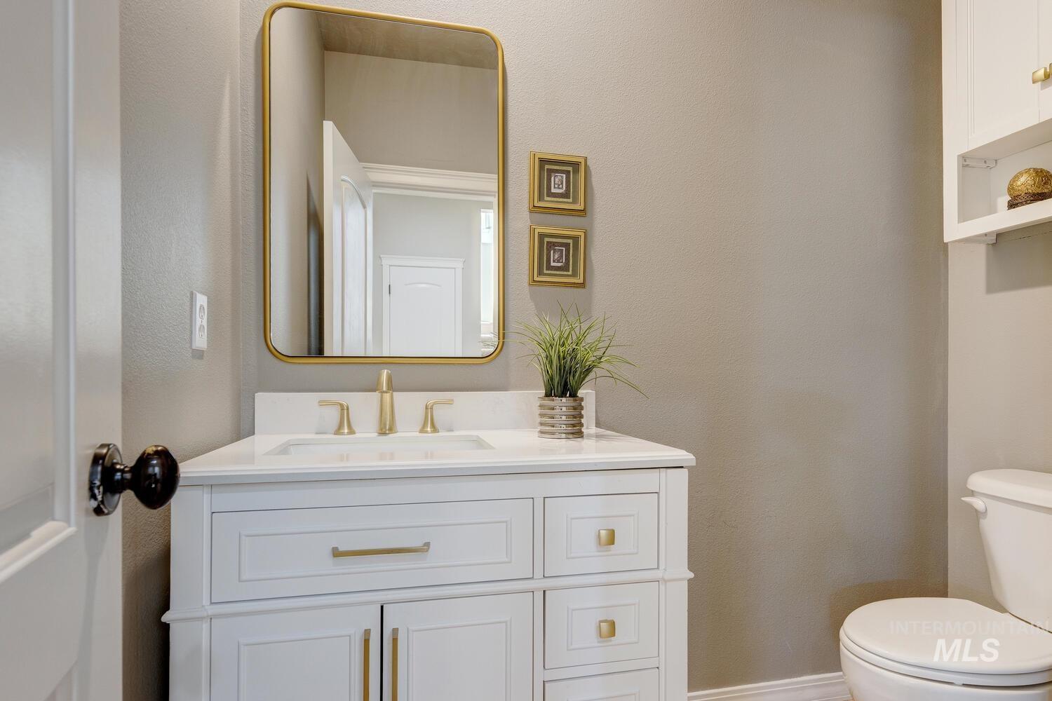 Bathroom with a textured wall and vanity
