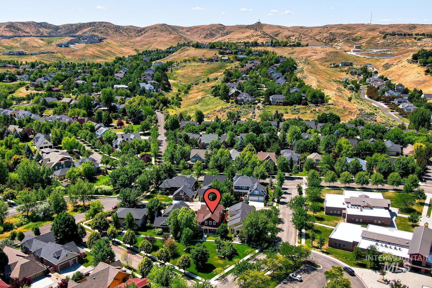 Aerial perspective of suburban area featuring a mountain backdrop