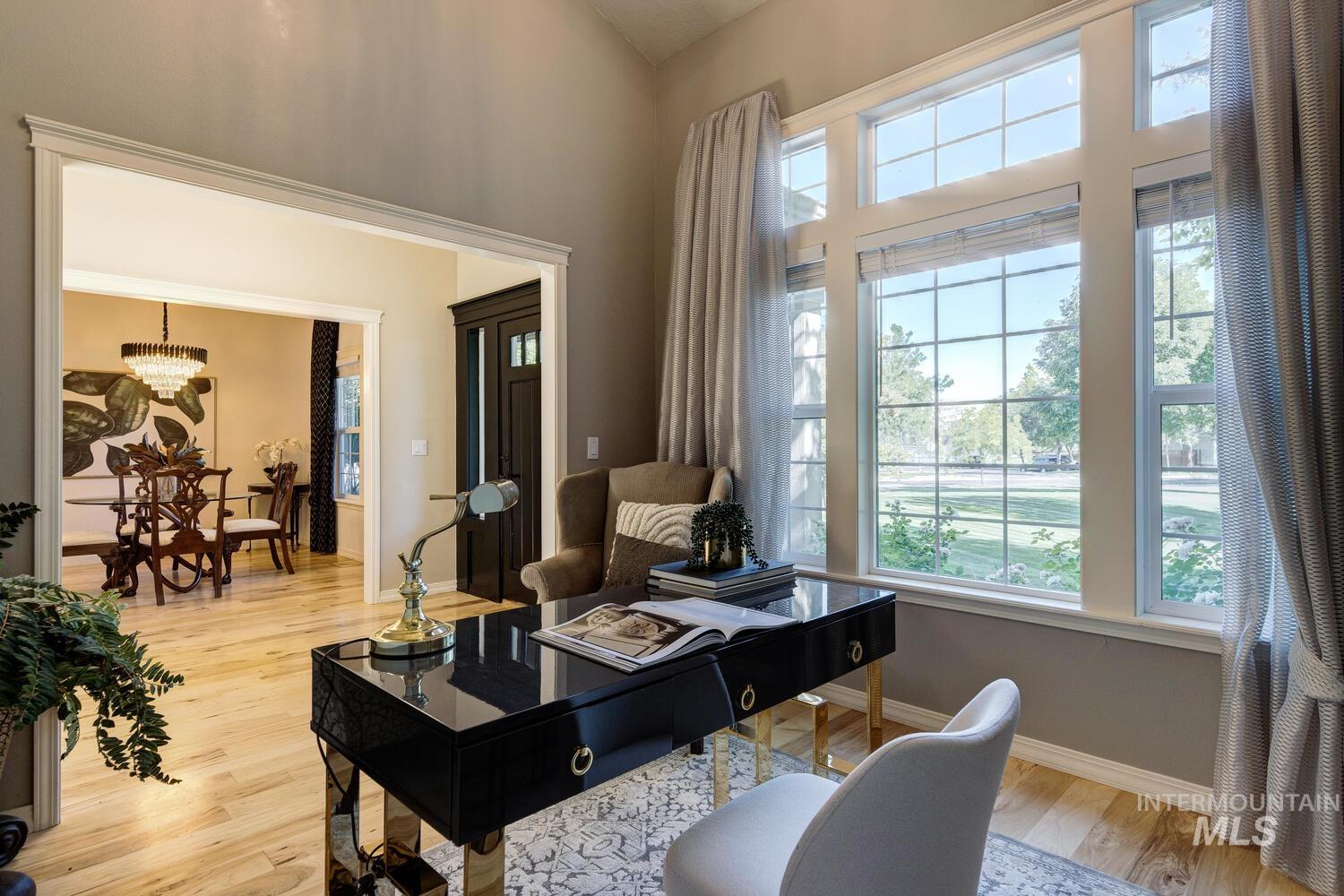 Living area with light wood-style floors and a chandelier