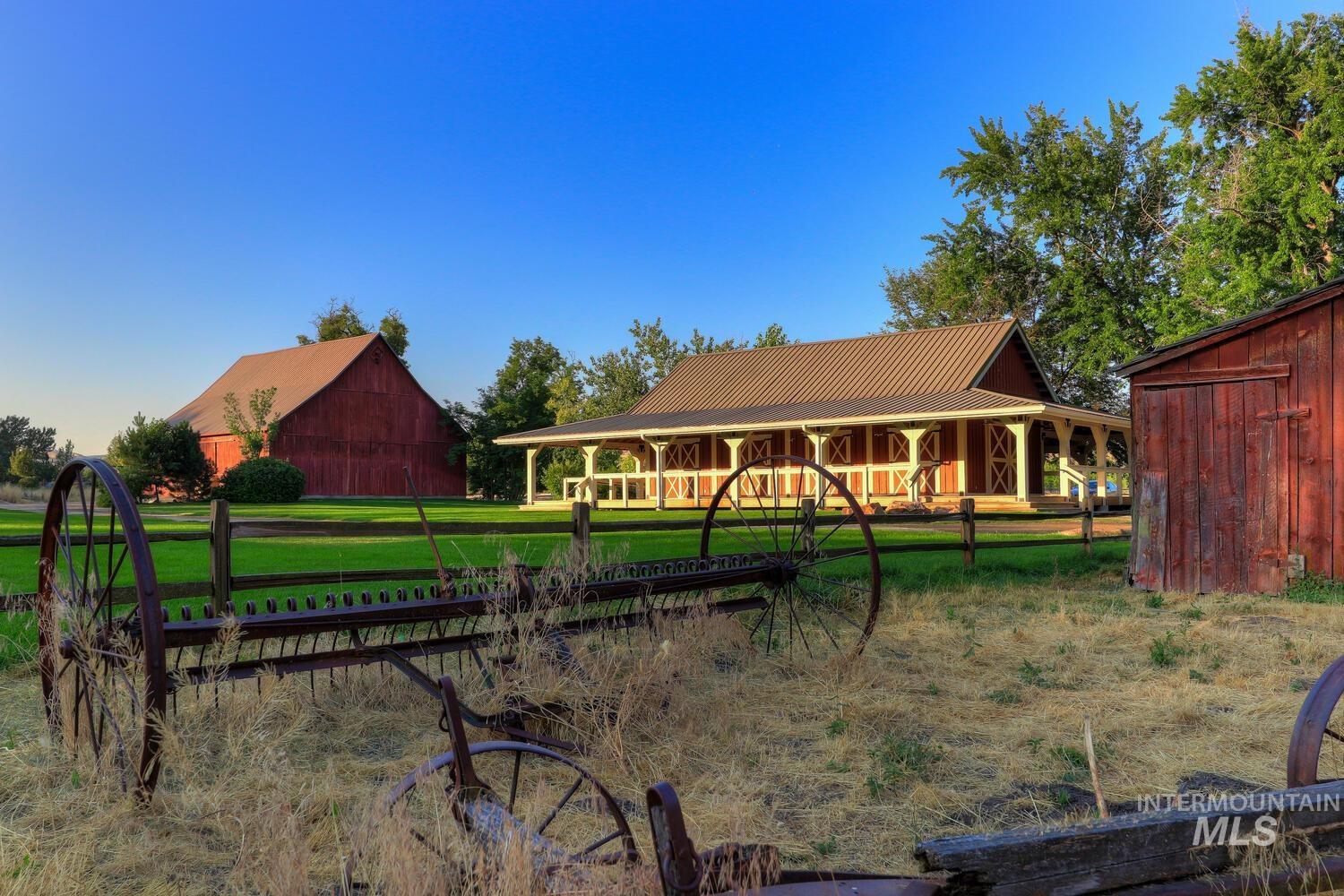 View of grassy yard with an outdoor structure, a barn, and covered porch
