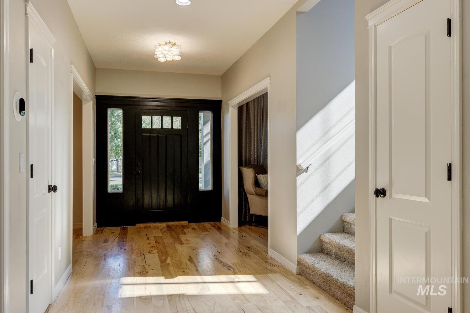 Foyer entrance with light wood-style flooring and stairs
