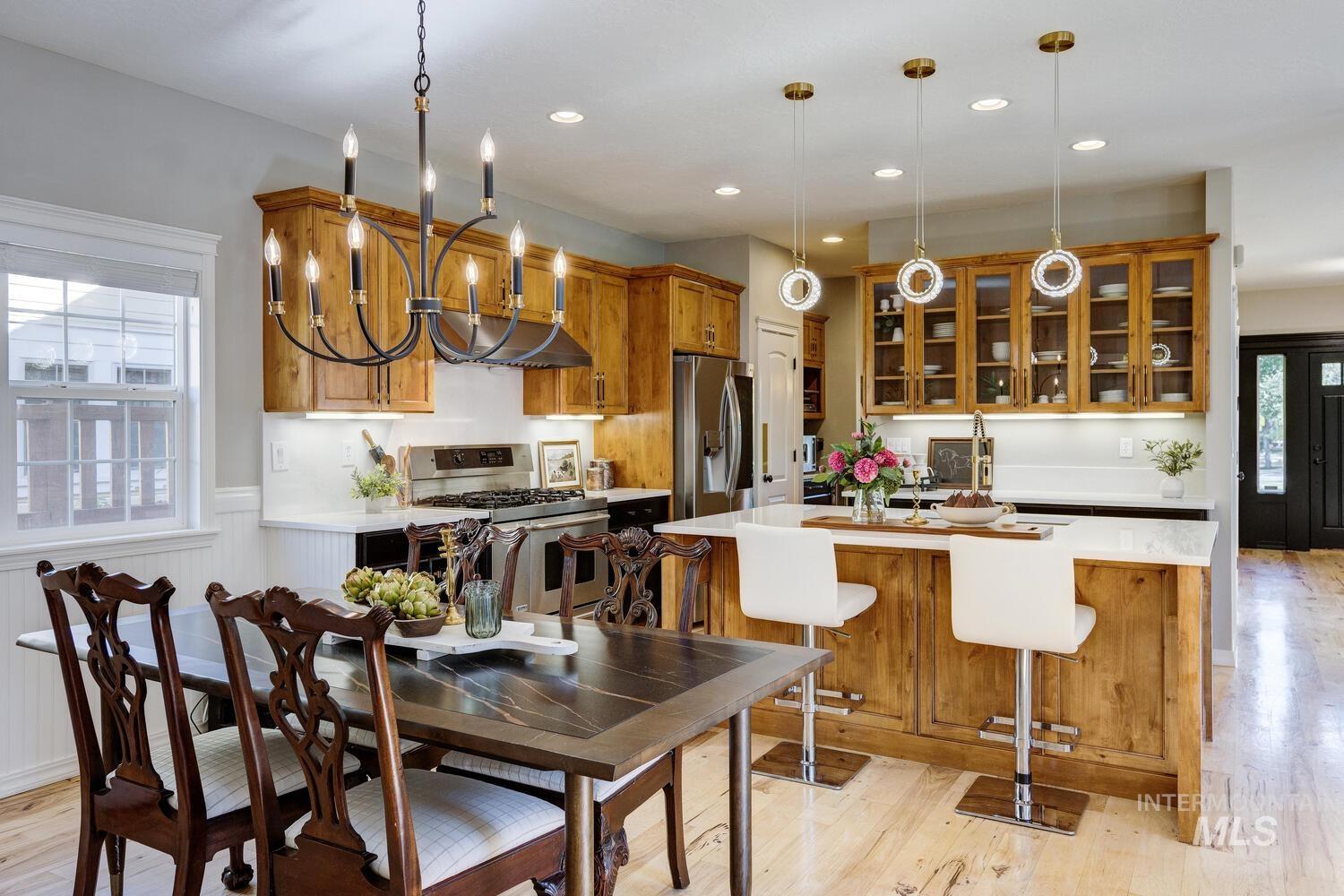 Dining area featuring light wood-type flooring, recessed lighting, and a chandelier