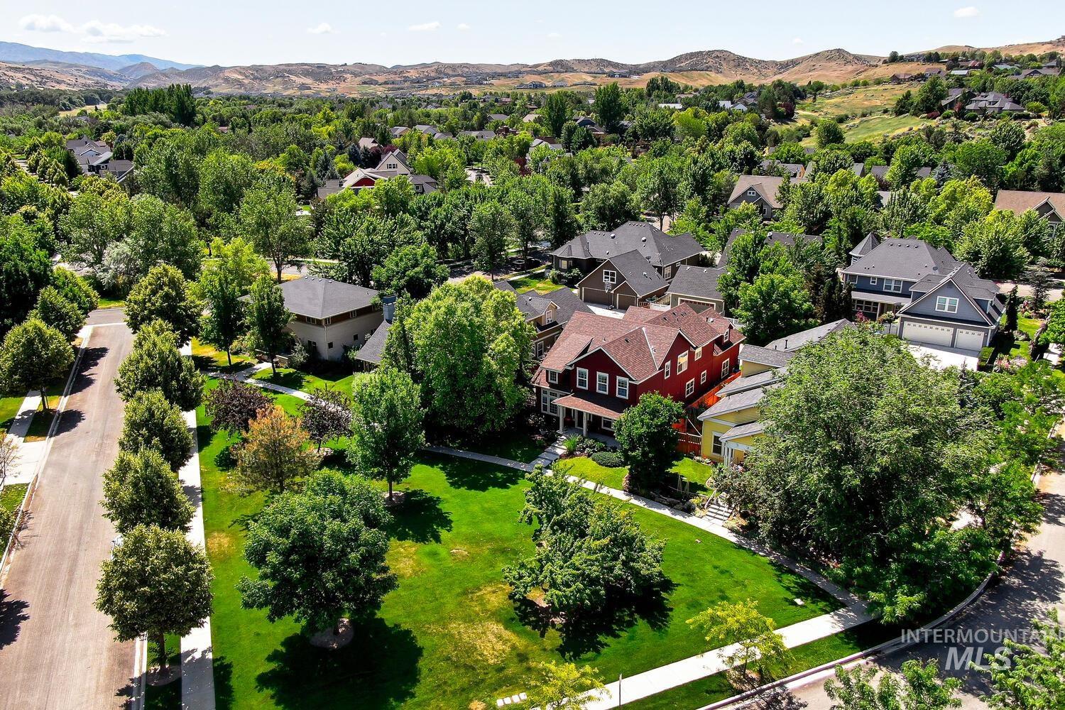 Aerial perspective of suburban area featuring a mountainous background