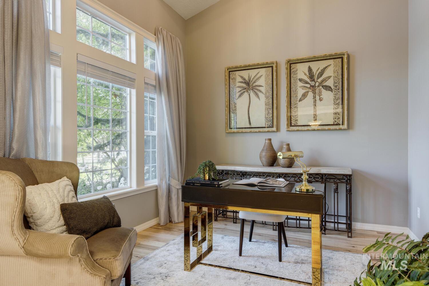 Office space with wood finished floors and baseboards