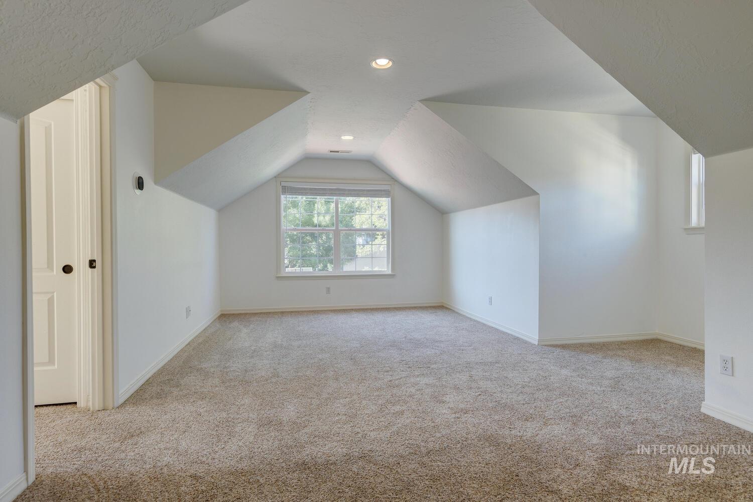 Bonus room featuring light colored carpet, vaulted ceiling, and recessed lighting