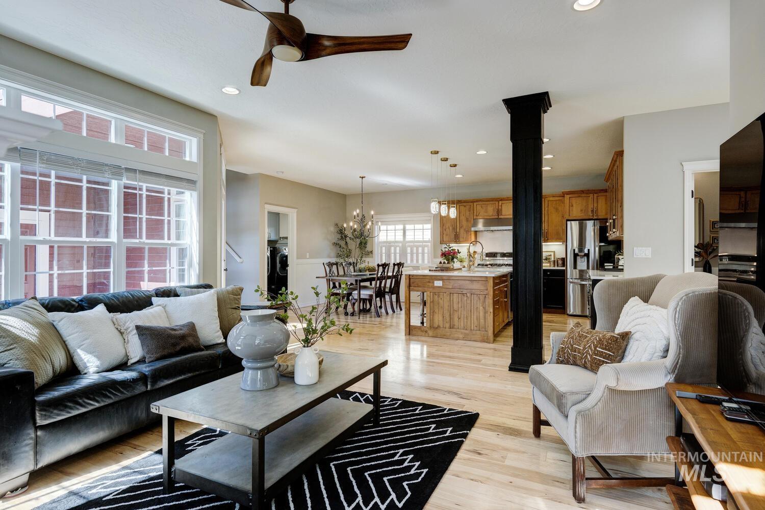 Living room with light wood-style floors, ceiling fan, and recessed lighting