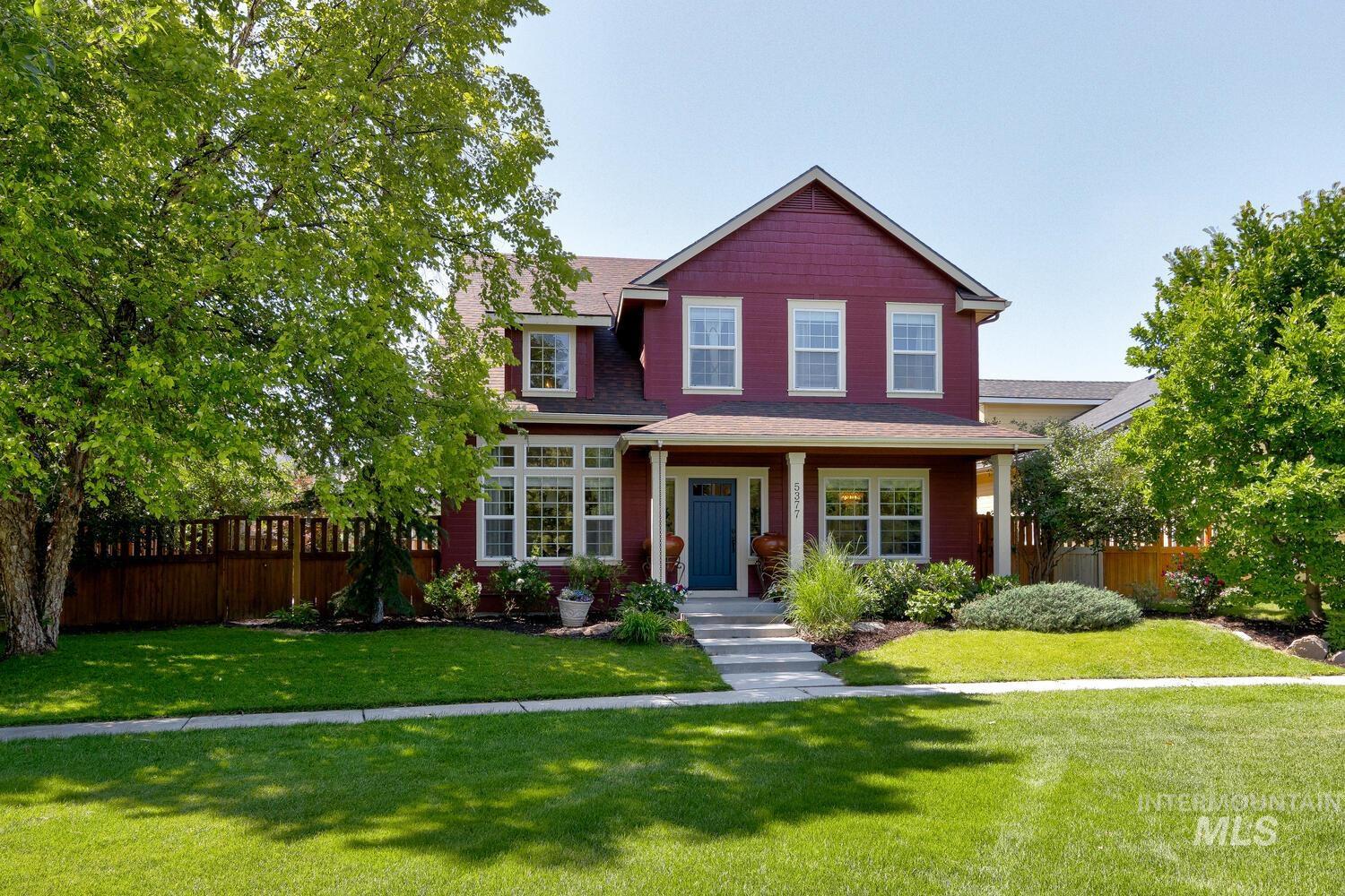 View of front facade with covered porch and roof with shingles