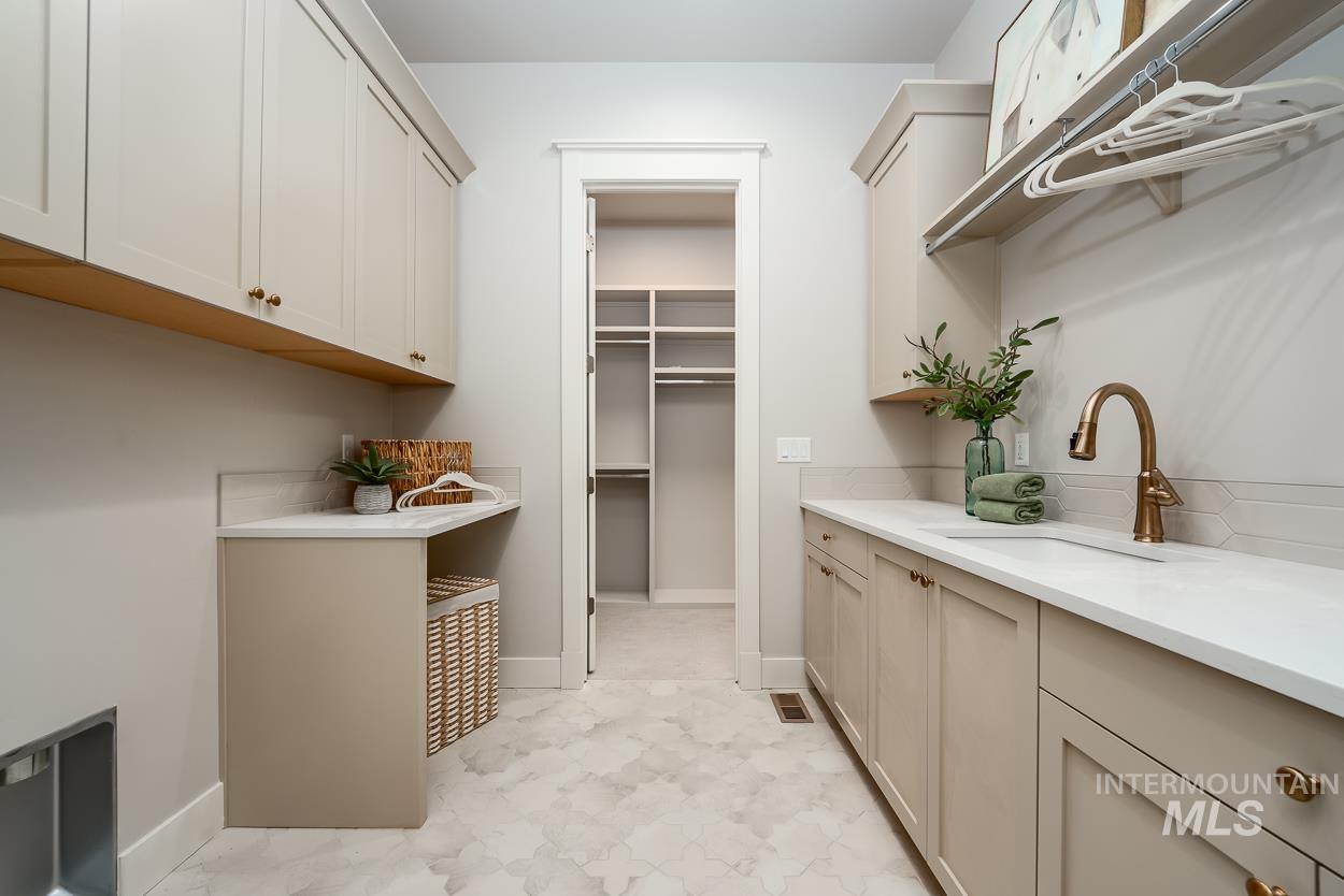 Laundry area with baseboards