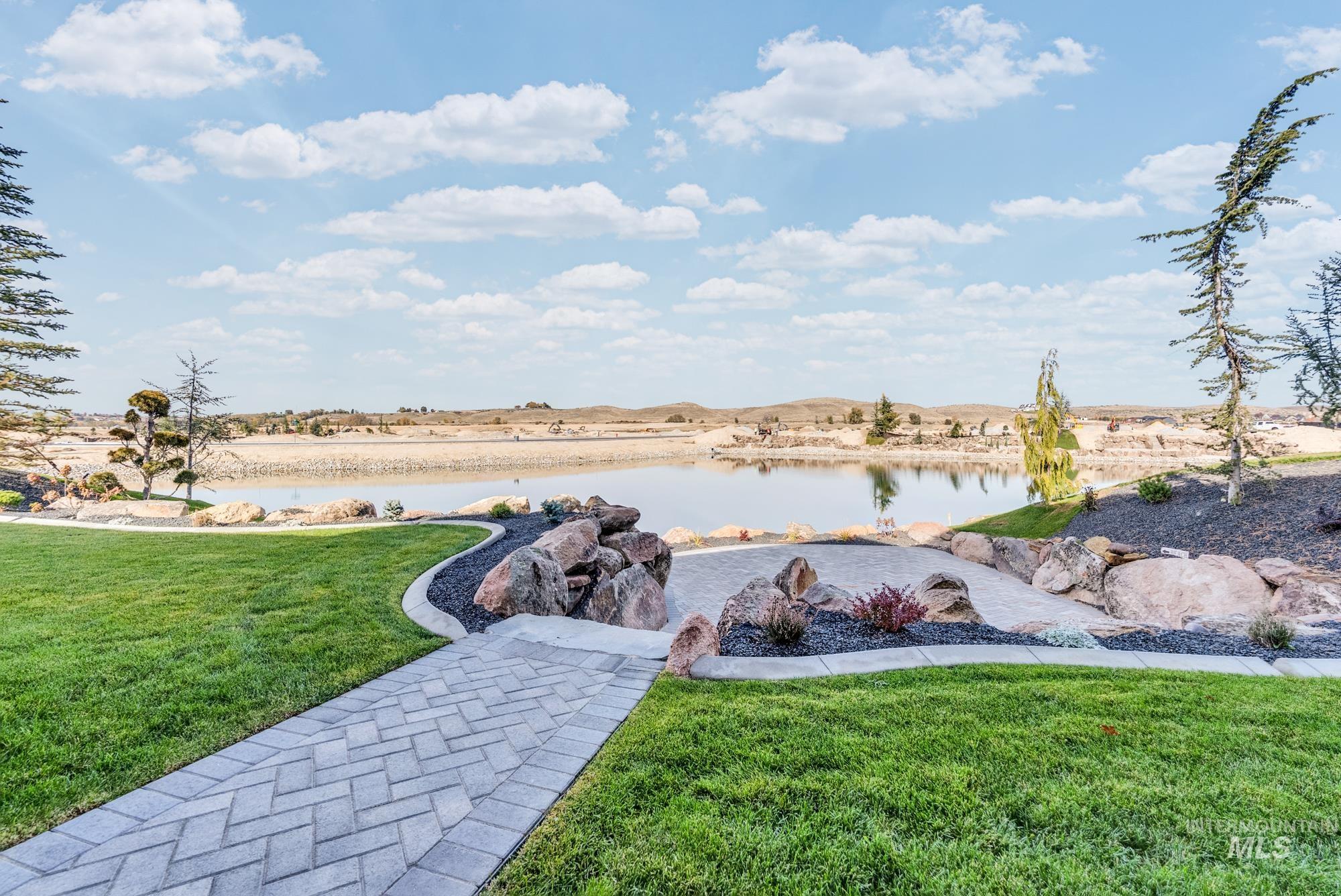 View of green lawn featuring a water view