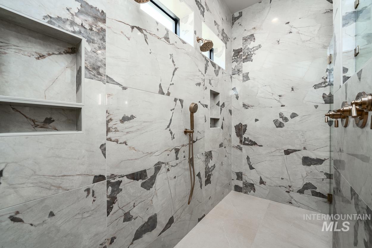 Full bathroom featuring a marble finish shower