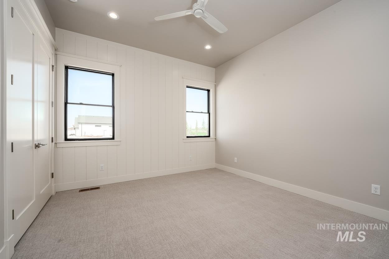 Spare room with light colored carpet, recessed lighting, lofted ceiling, and ceiling fan