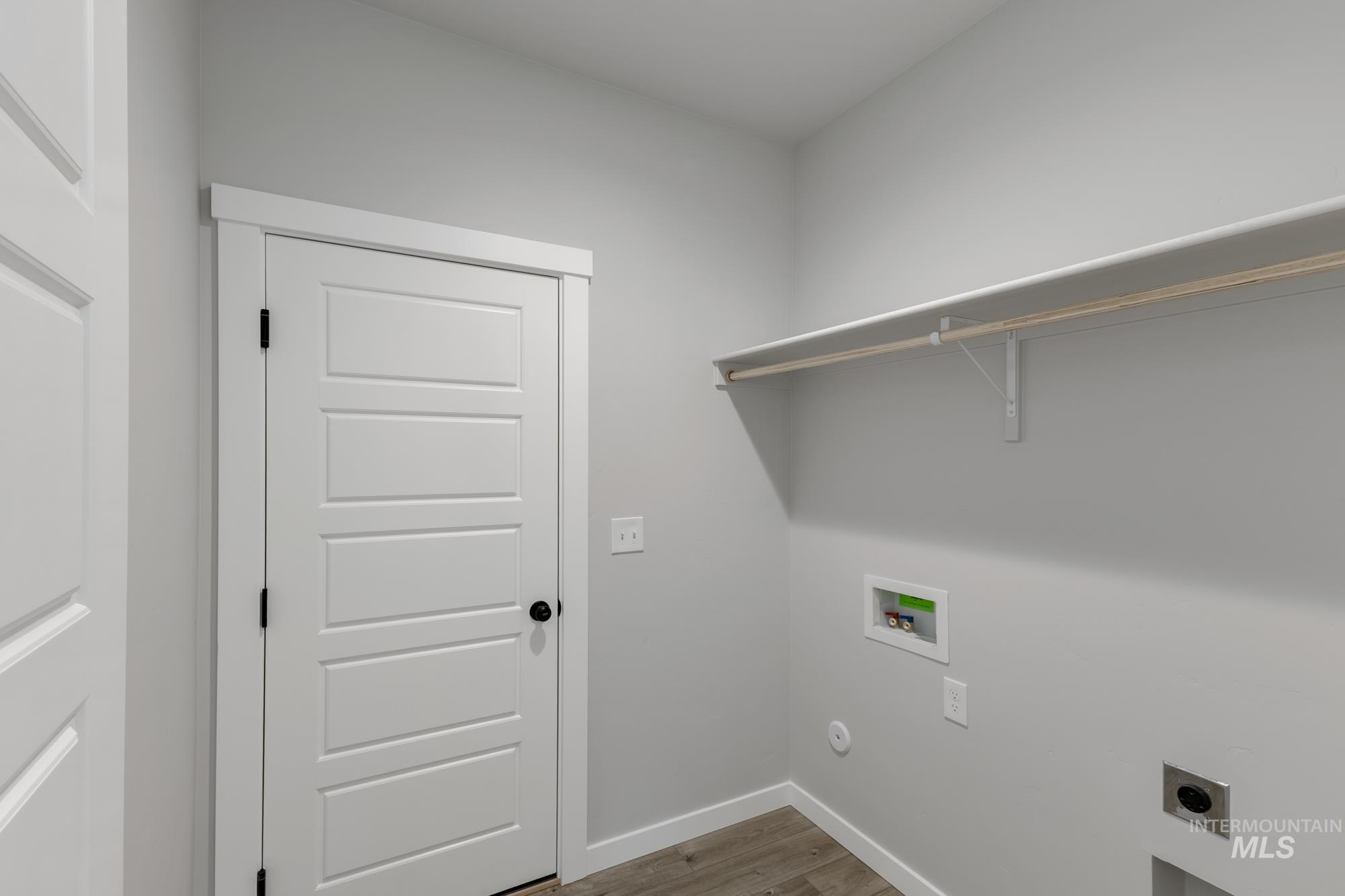 Laundry room featuring light wood-style floors, electric dryer hookup, and hookup for a washing machine
