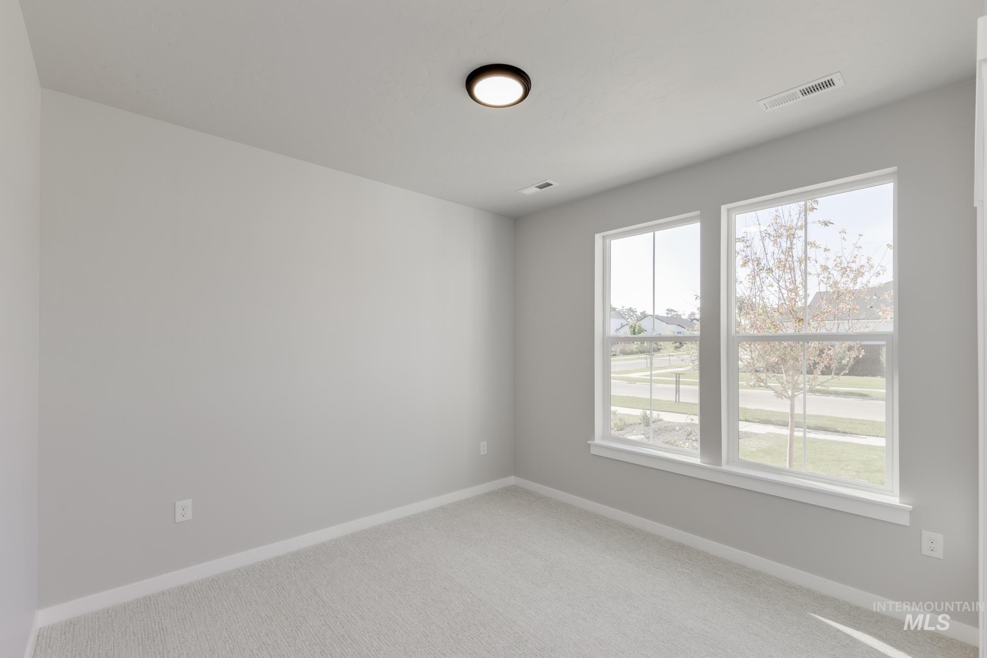 Unfurnished room with carpet floors and baseboards
