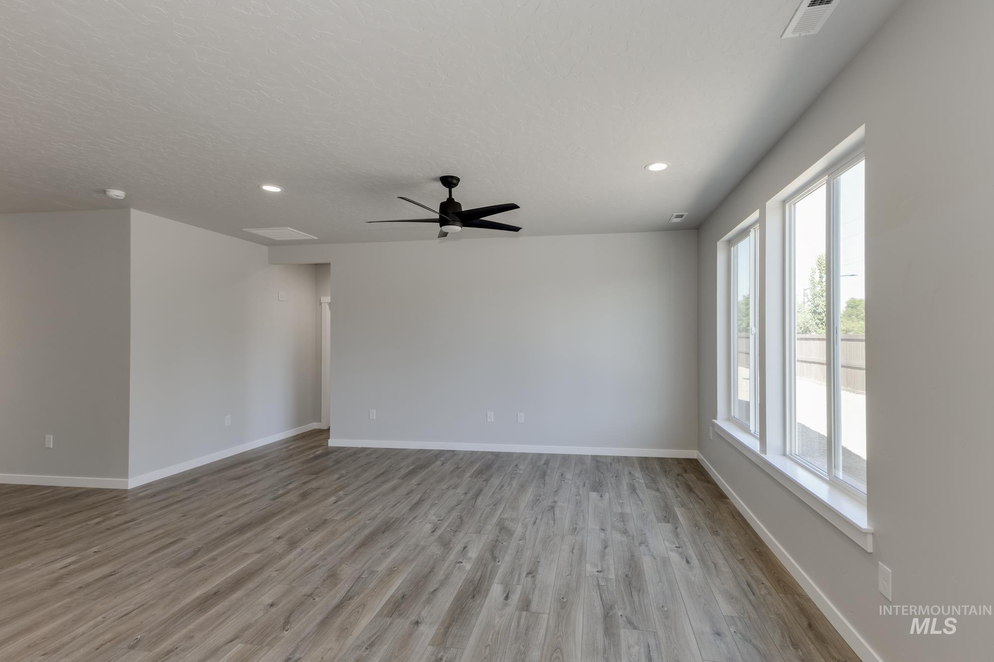 Unfurnished room featuring light wood-style floors, recessed lighting, and a ceiling fan