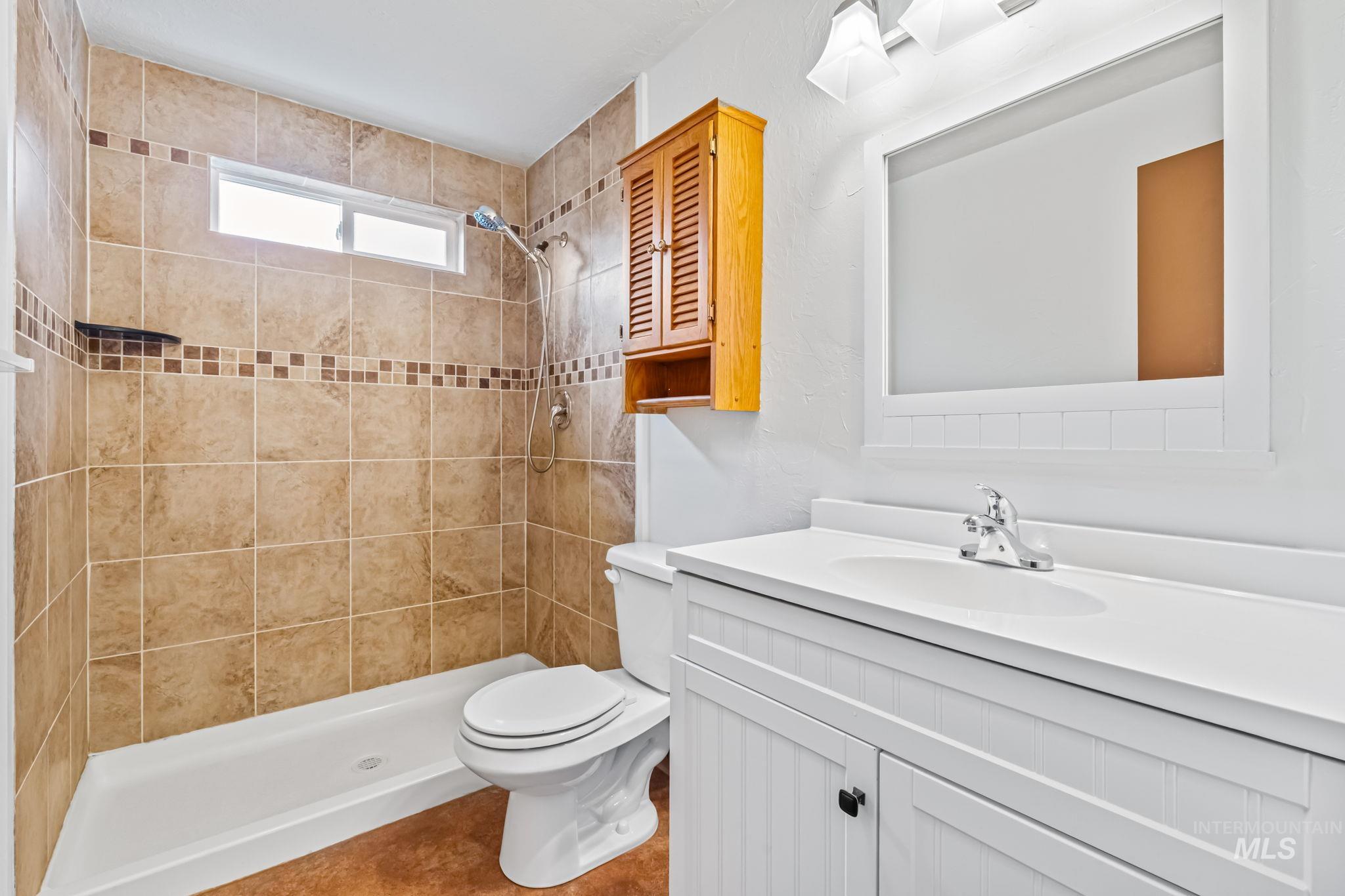 Full bath featuring vanity and a shower stall