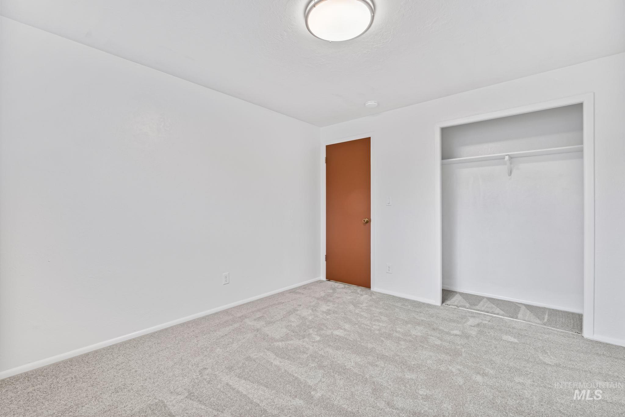 Unfurnished bedroom featuring carpet floors and a closet