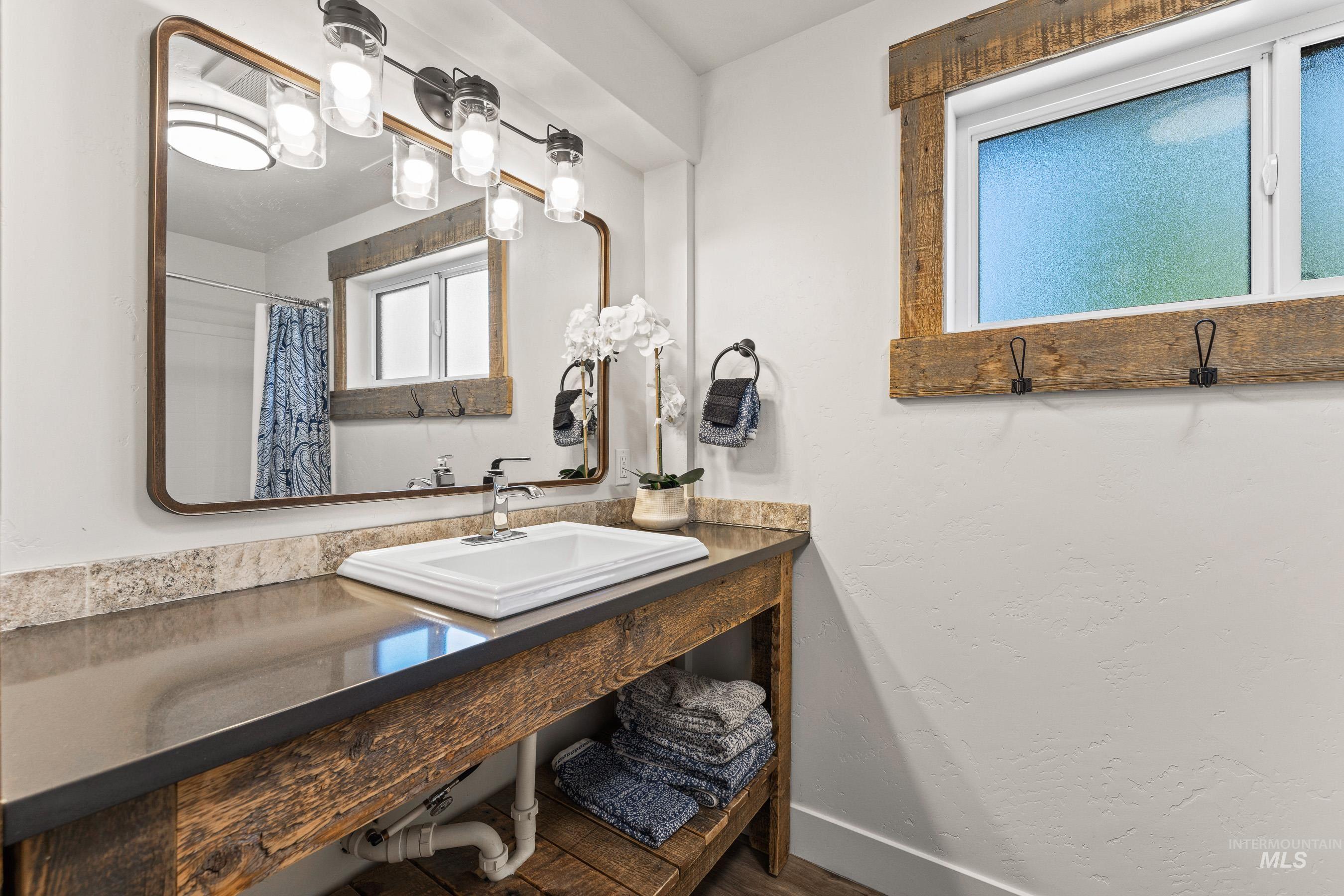 Full bathroom with vanity and curtained shower