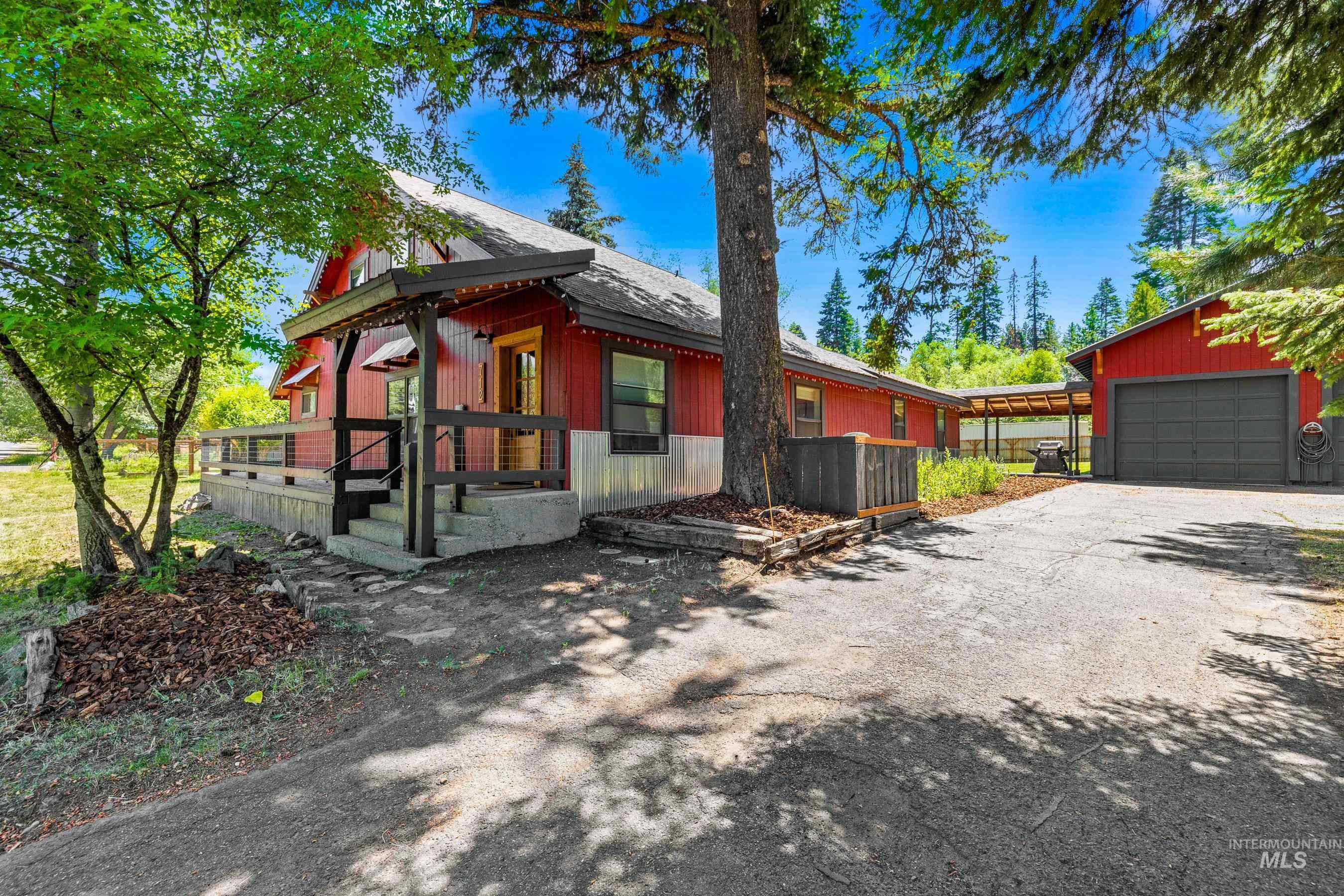 View of property exterior featuring a detached garage