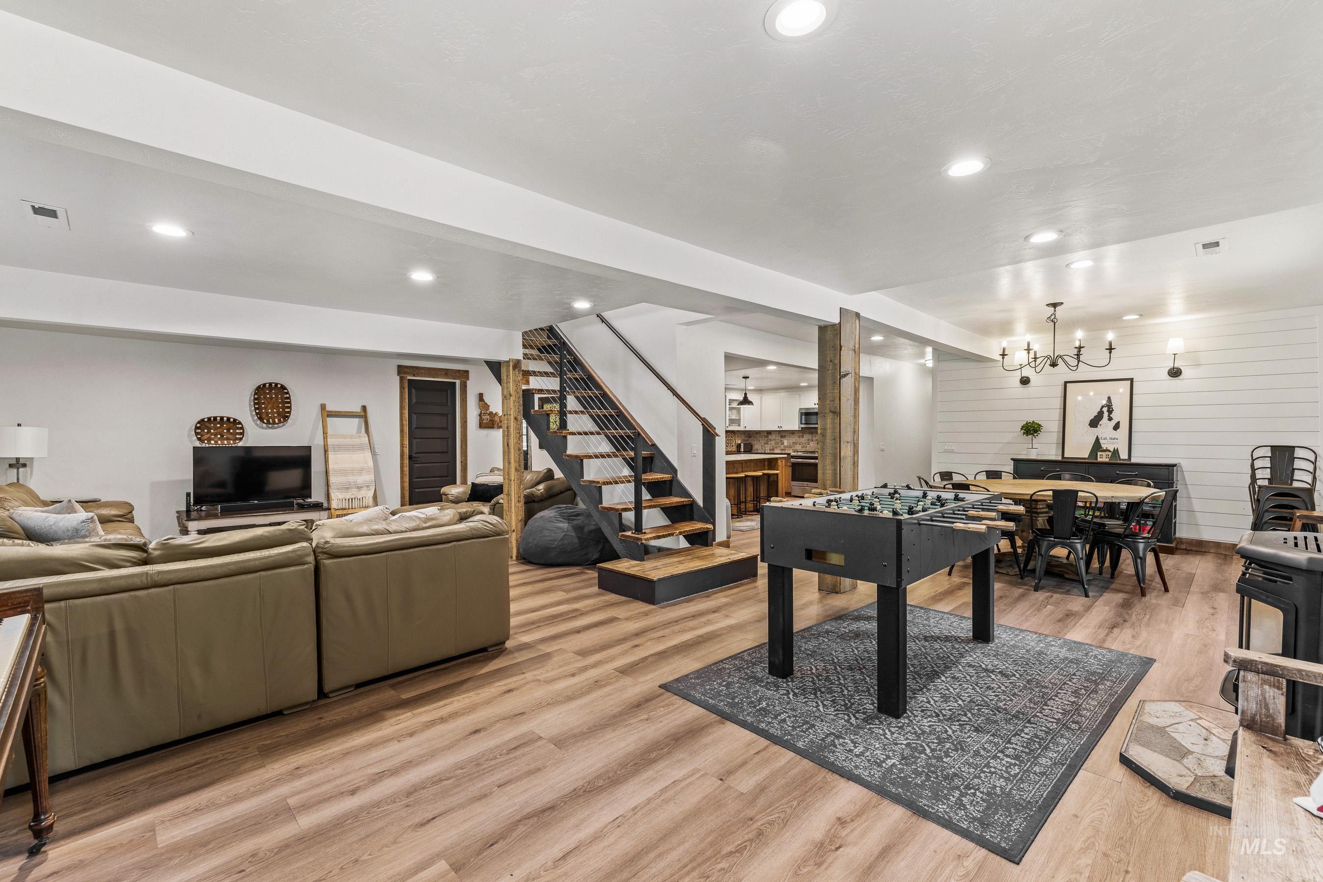 Living/dining room with a chandelier, recessed lighting, and light wood-type flooring