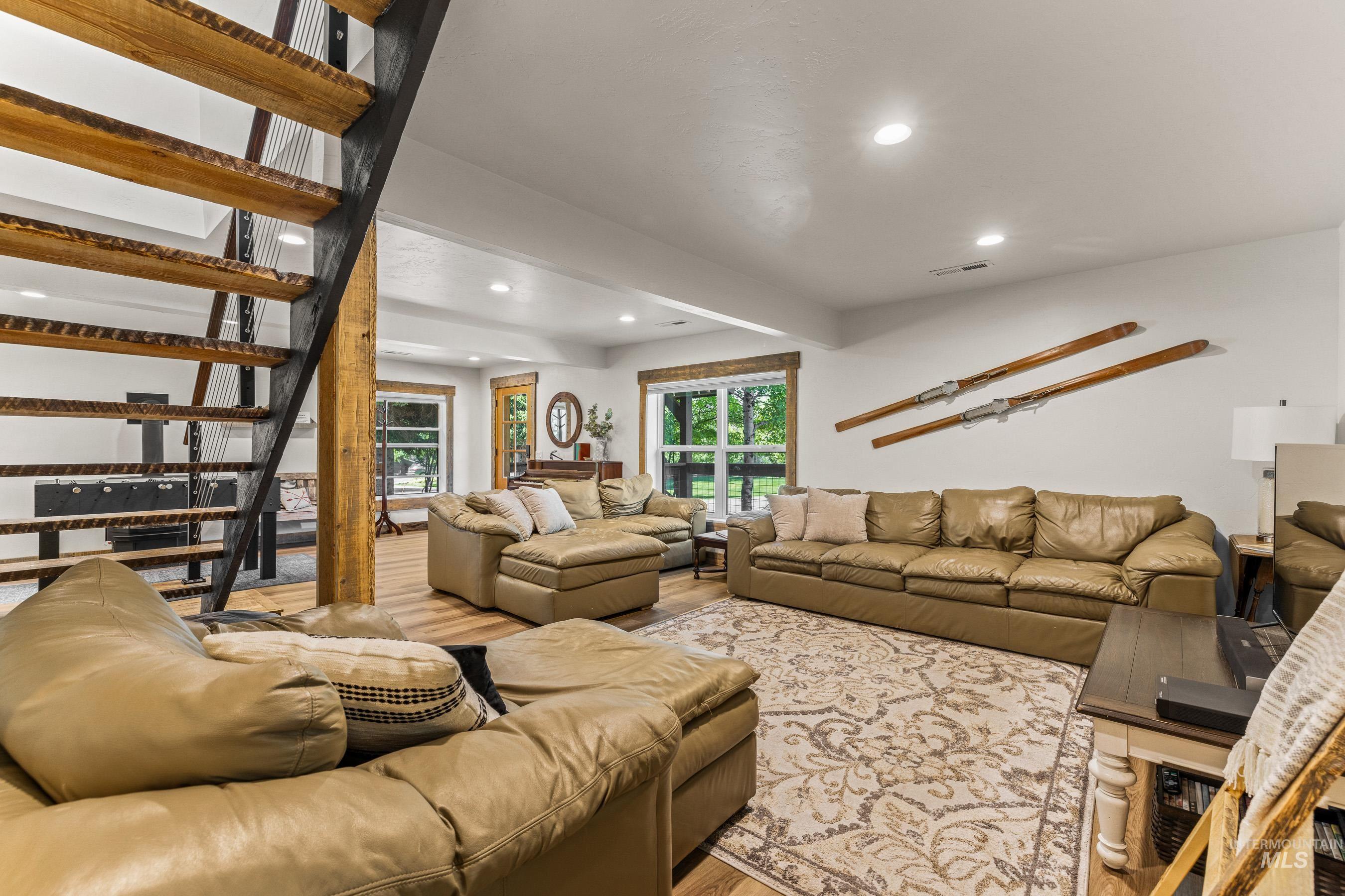 Living area featuring recessed lighting, wood finished floors, and stairs