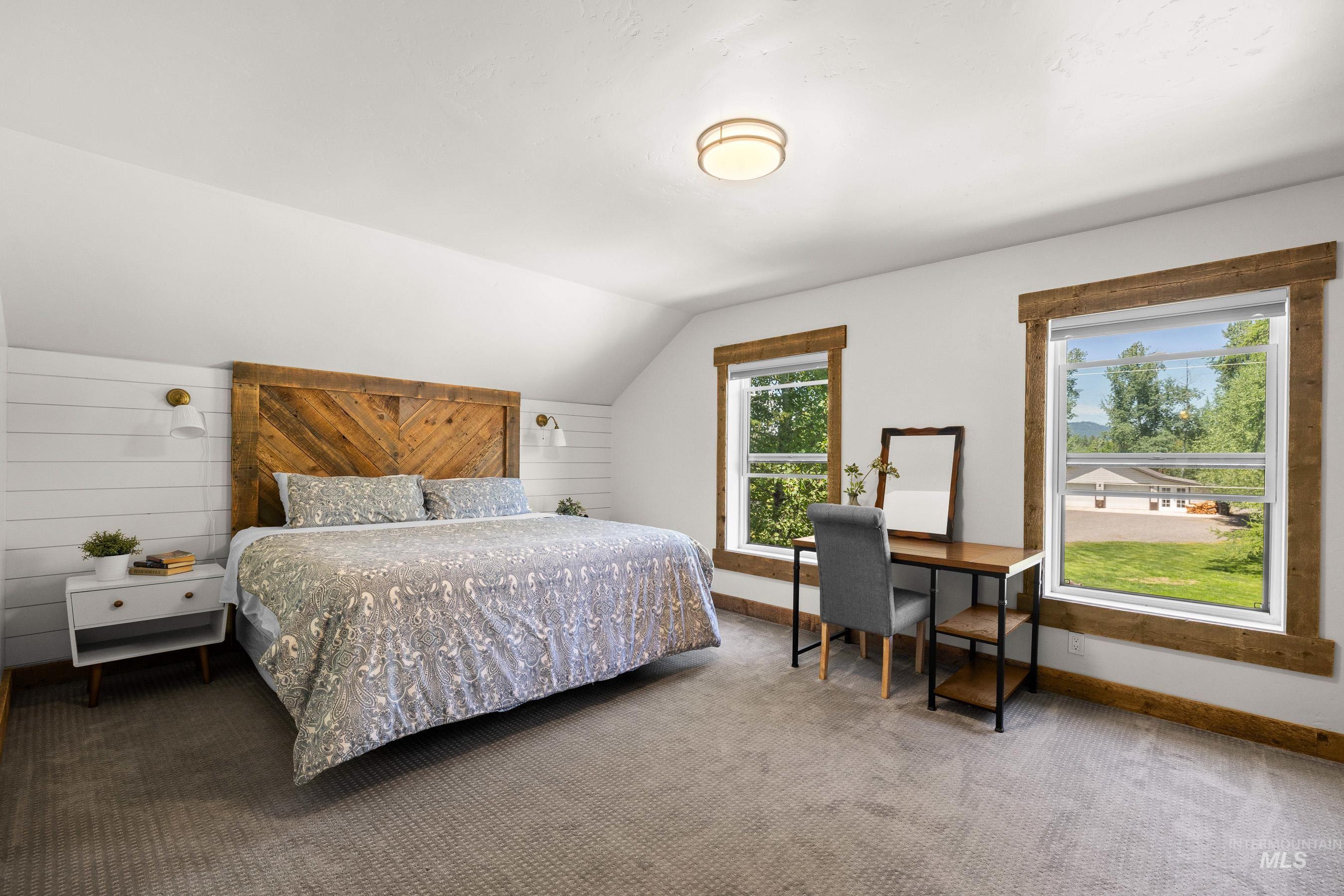 Bedroom with lofted ceiling and carpet