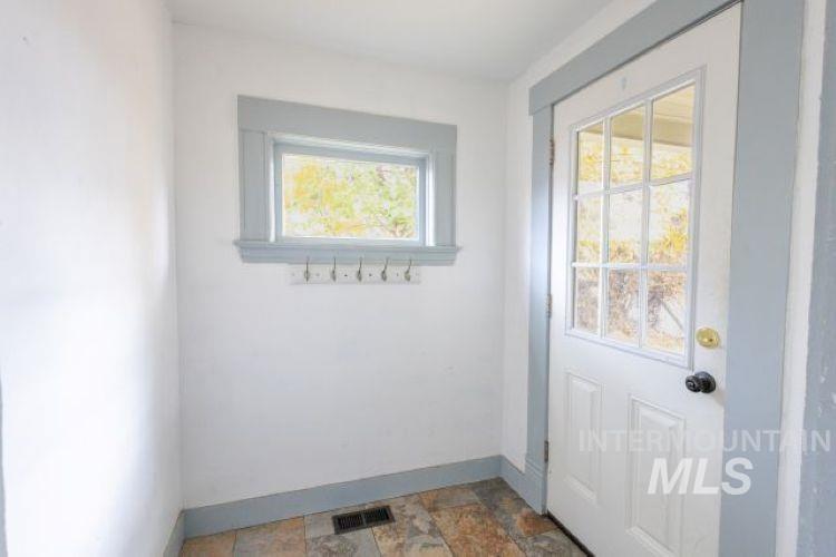 Entryway with baseboards and stone finish flooring