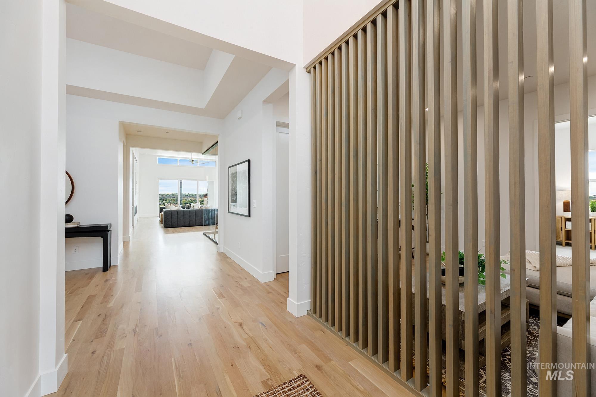 Hall featuring light wood-style flooring and baseboards