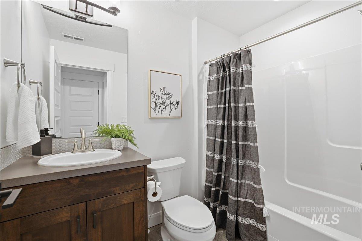 Full bathroom with vanity and toilet