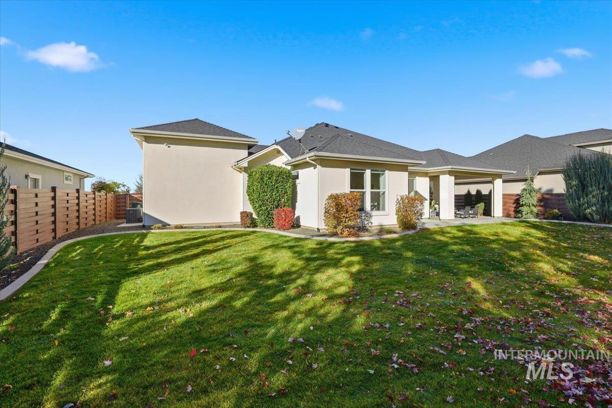 Back of property featuring stucco siding