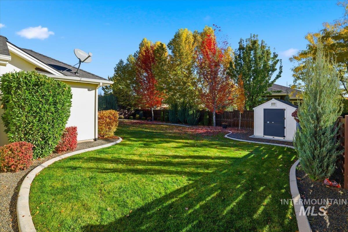 Fenced backyard with a storage unit