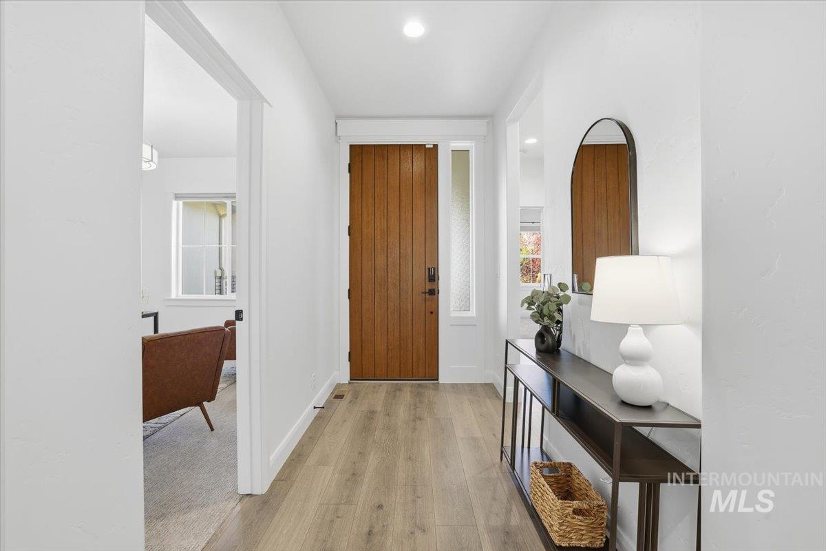 Entryway featuring light wood-style flooring and recessed lighting