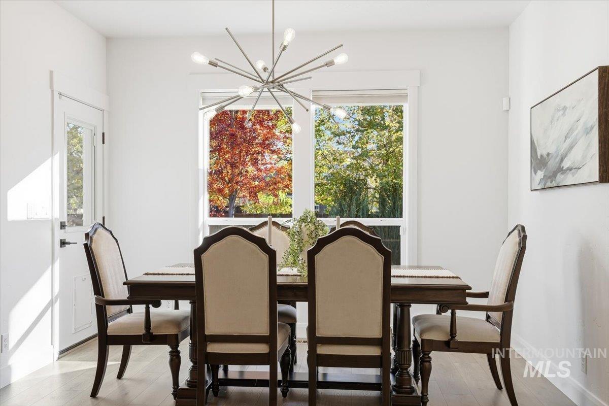 Dining area featuring a chandelier and light wood-style flooring