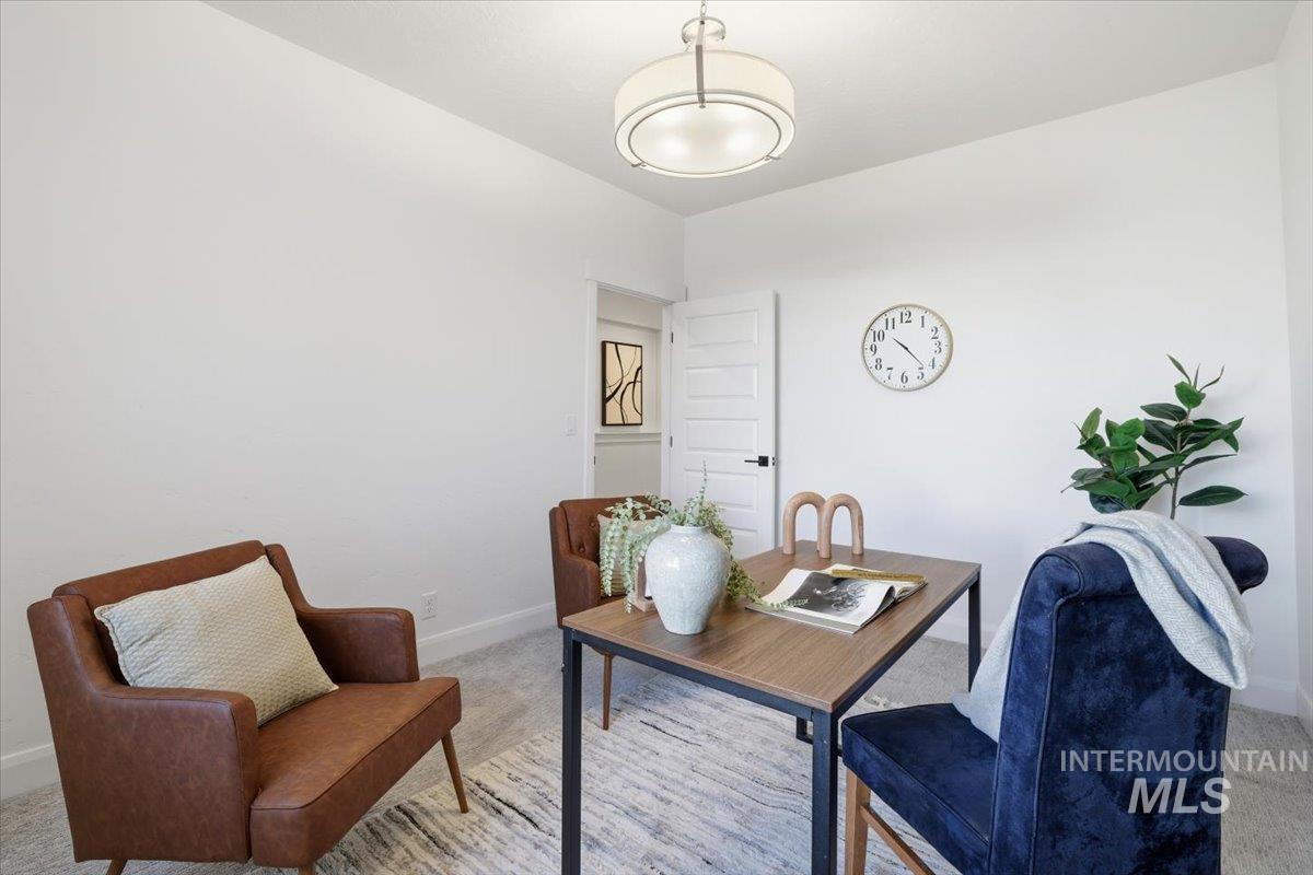 Home office with carpet floors and baseboards