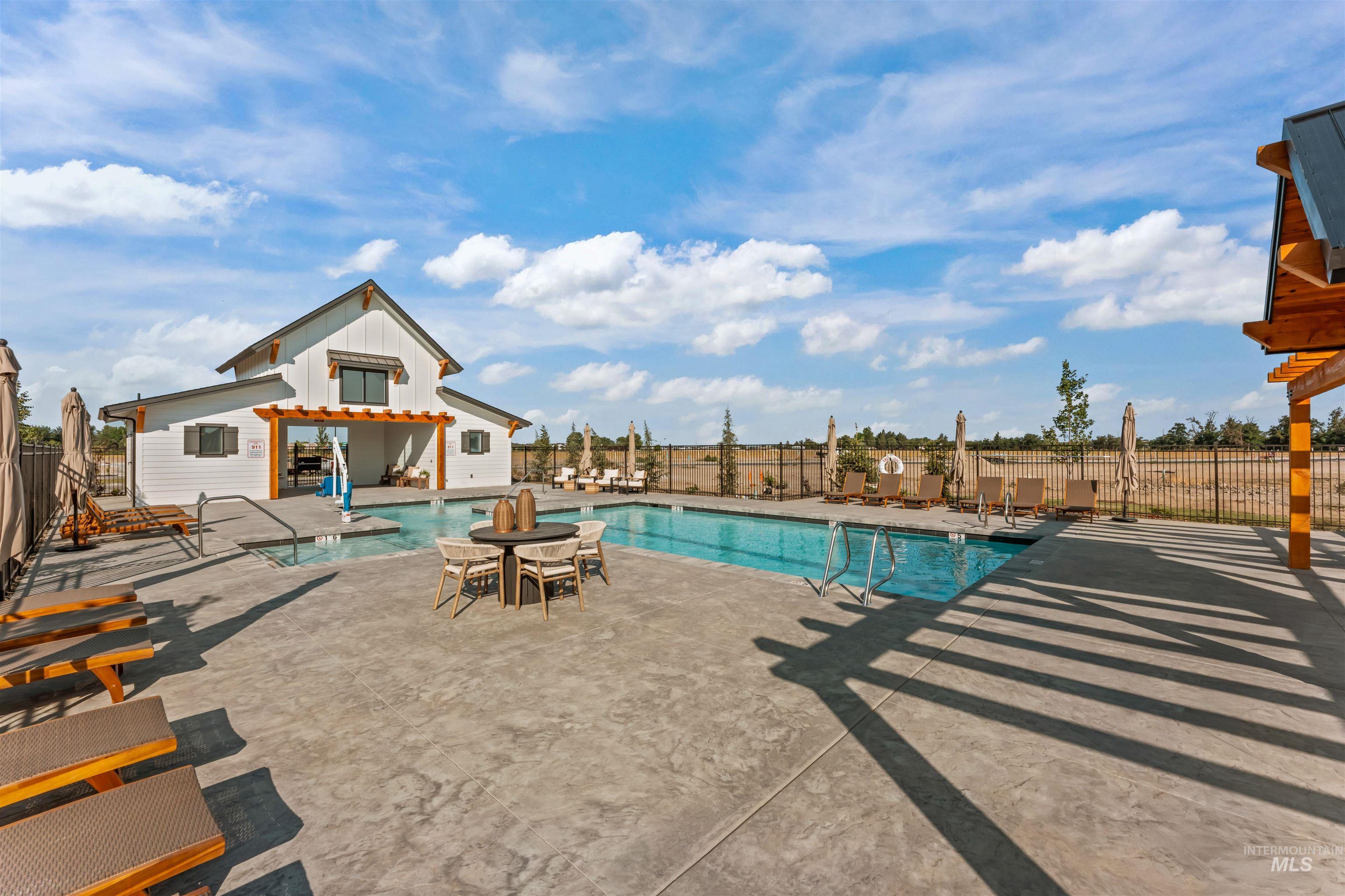 Community pool featuring a patio area and an outdoor structure