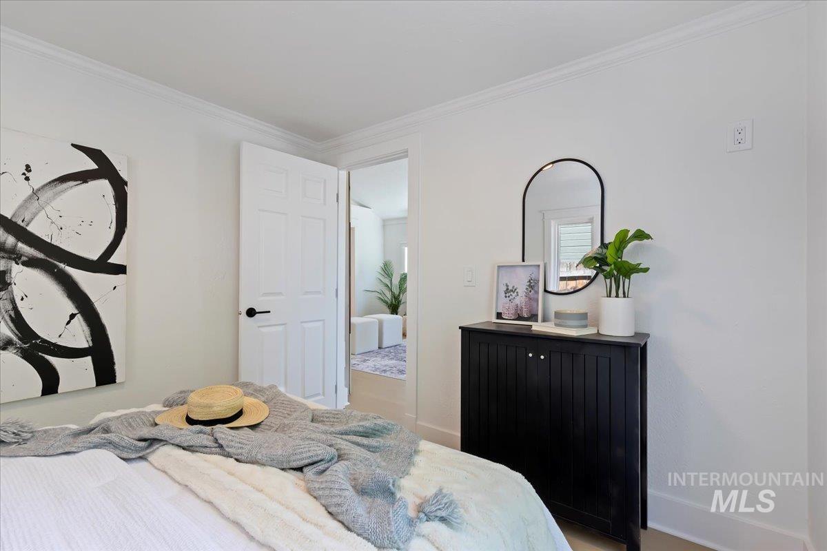 Bedroom with baseboards and ornamental molding