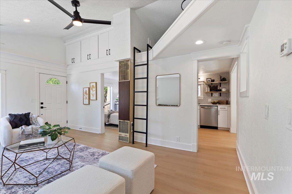 Living room with light wood-style flooring, recessed lighting, a ceiling fan, and a textured ceiling