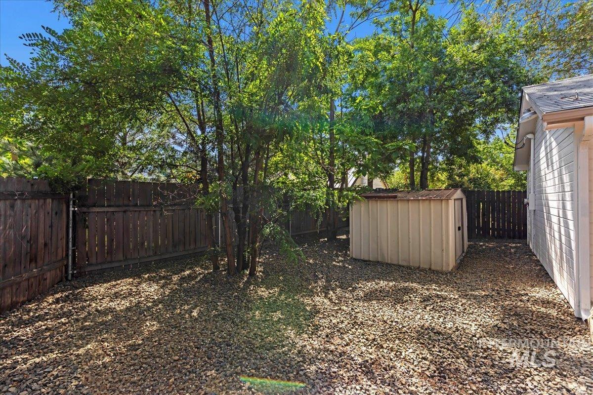 Fenced backyard with a storage unit