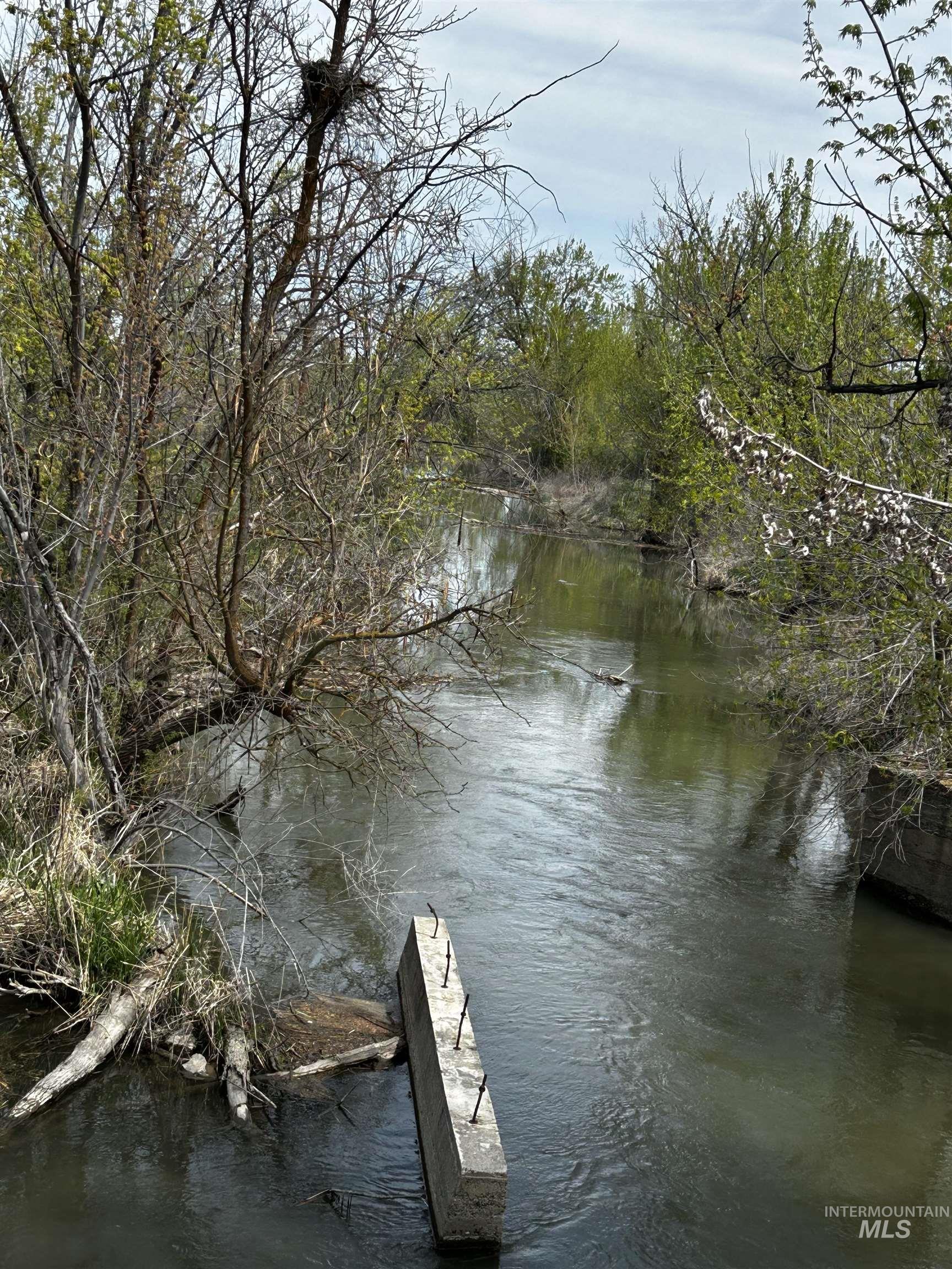 Dock area with a water view and a wooded view