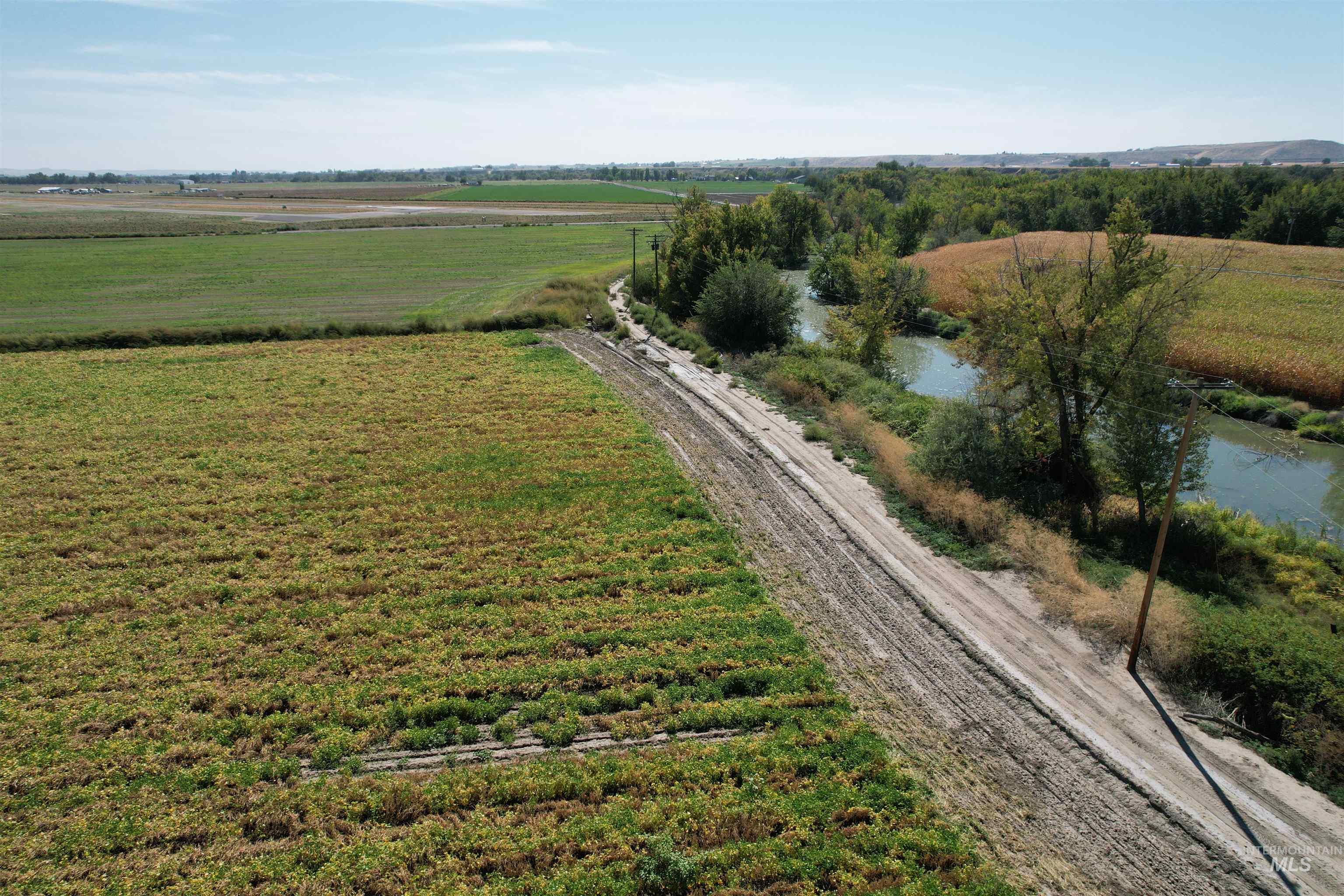 Aerial view of sparsely populated area with farmland and a large body of water